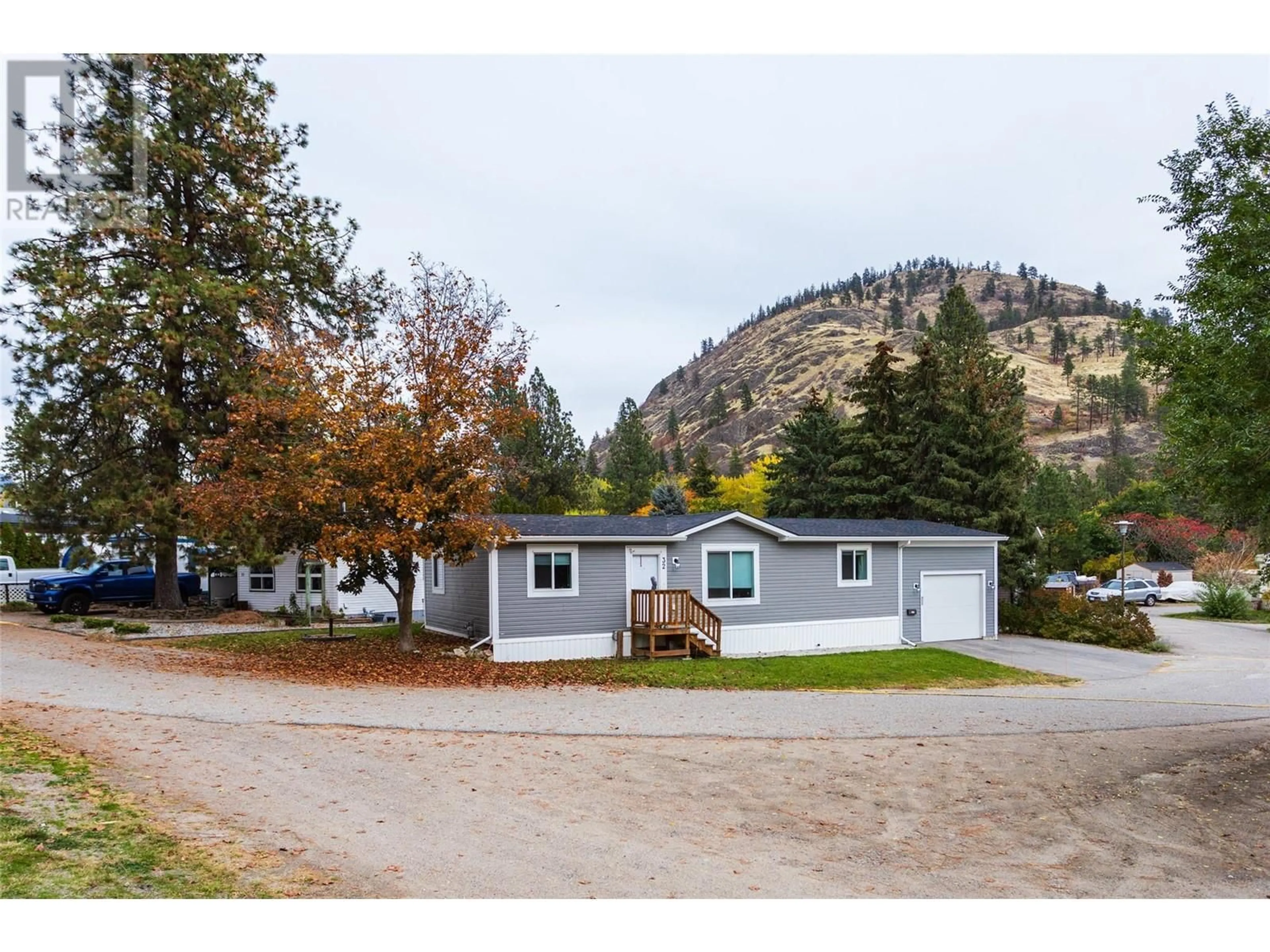 Home with vinyl exterior material, mountain view for 1999 Highway 97 S Unit# 32, West Kelowna British Columbia V1Z1B2