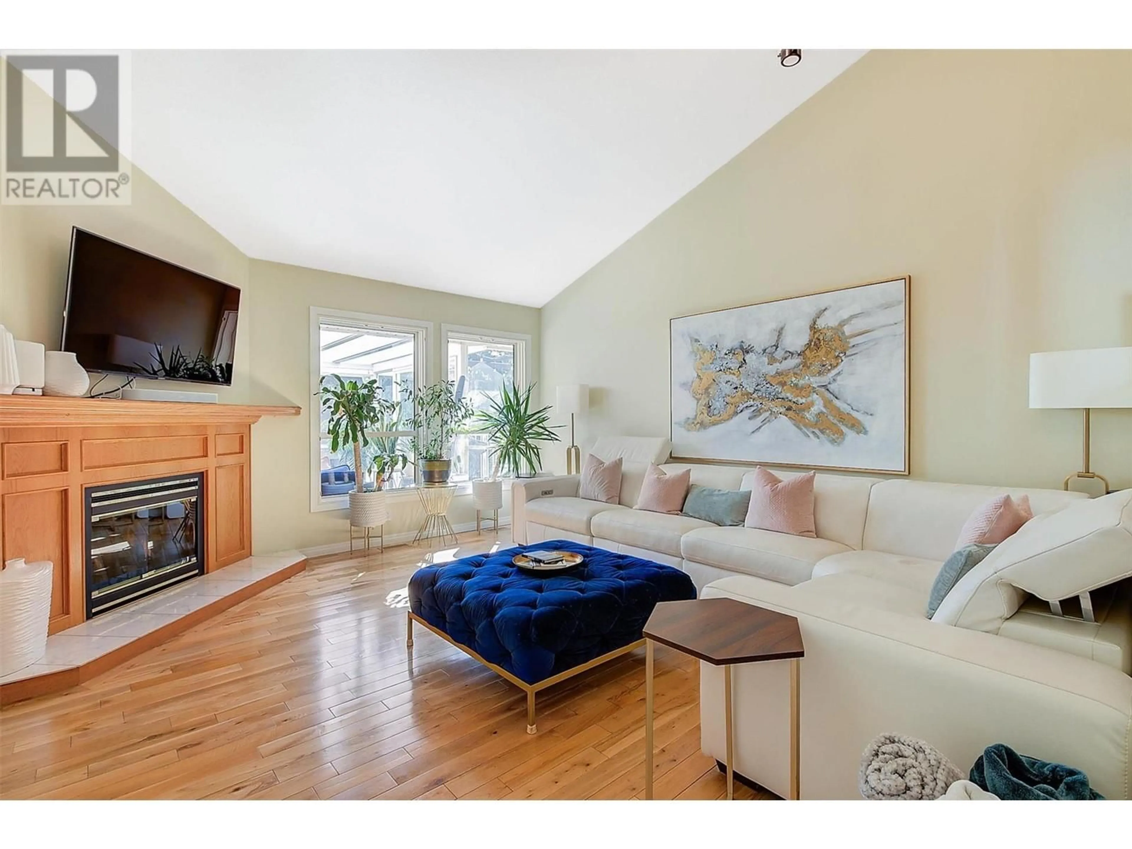 Living room with furniture, wood/laminate floor for 3923 Lakevale Place, Kelowna British Columbia V1W3Z5