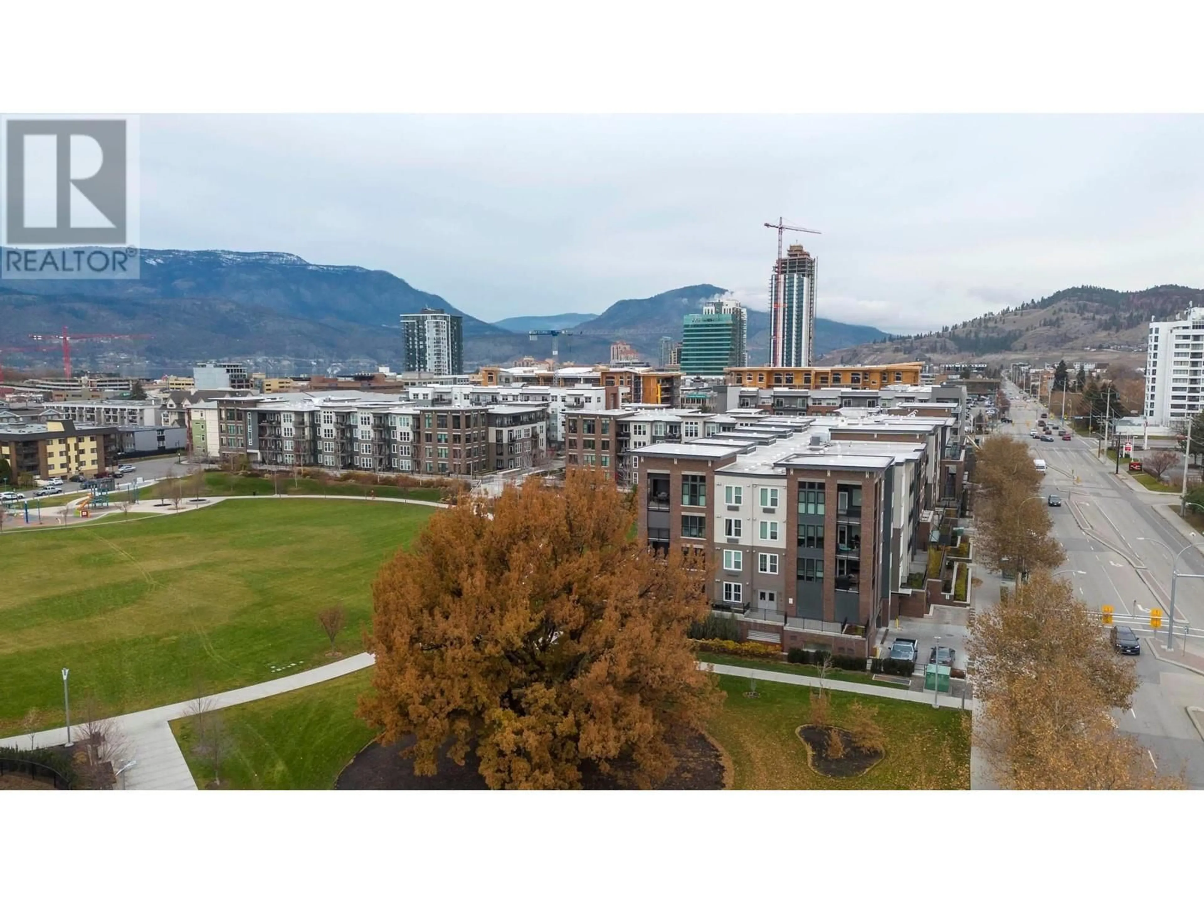 A pic from outside/outdoor area/front of a property/back of a property/a pic from drone, mountain view for 1770 Richter Street Unit# 206, Kelowna British Columbia V1Y0E6