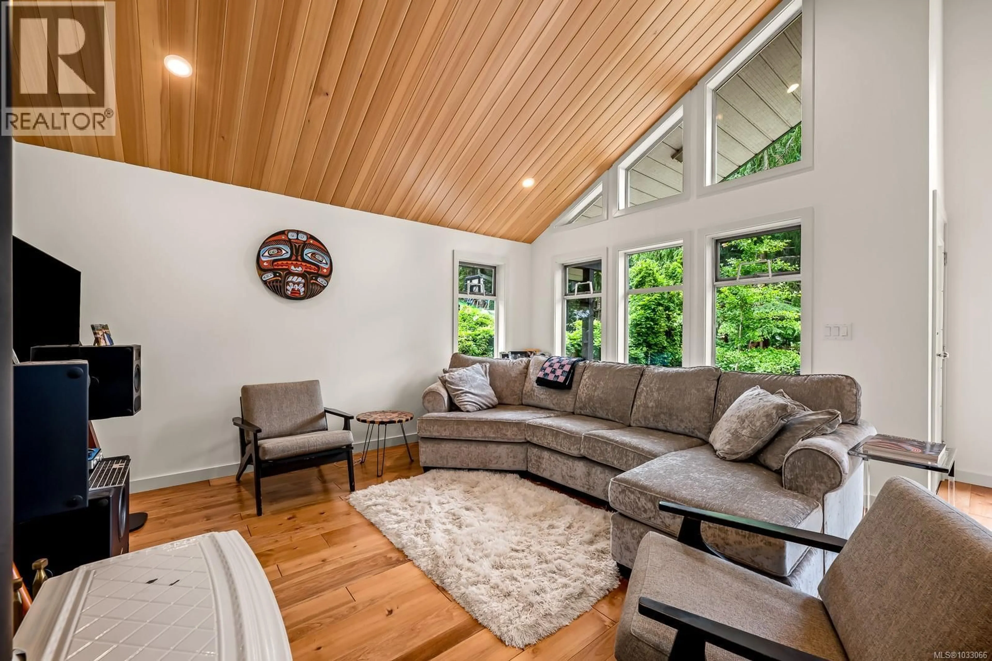 Living room with furniture, wood/laminate floor for 1677 BAIKIE ROAD, Denman Island British Columbia V0R1T0