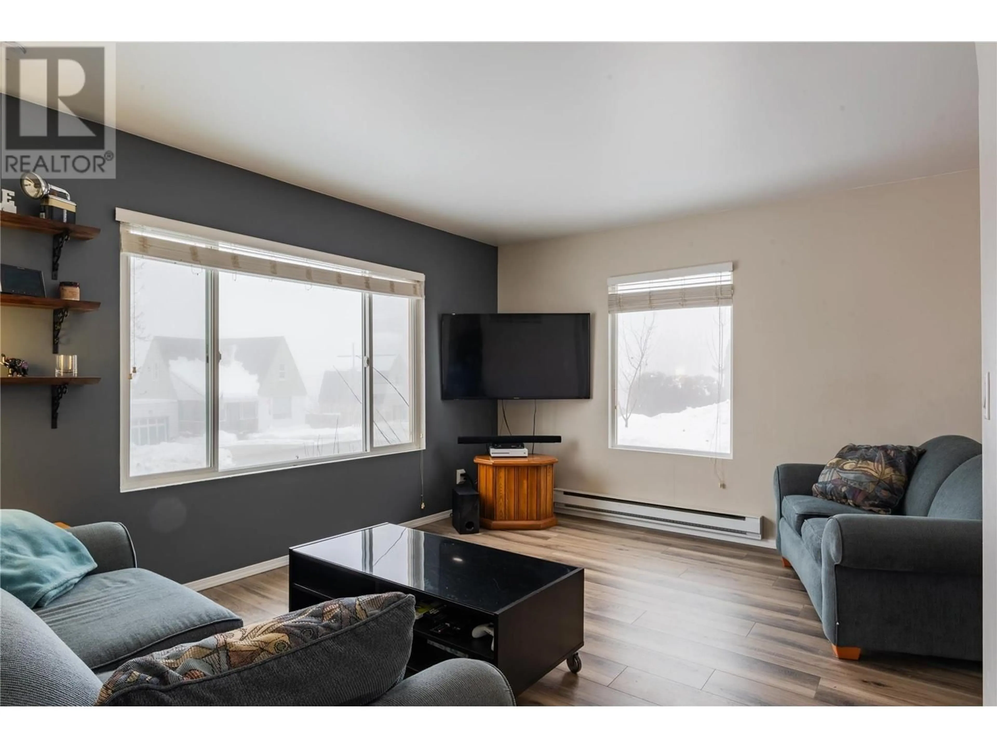 Living room with furniture, wood/laminate floor for 615 DICKENS Street, Warfield British Columbia V1R2B5