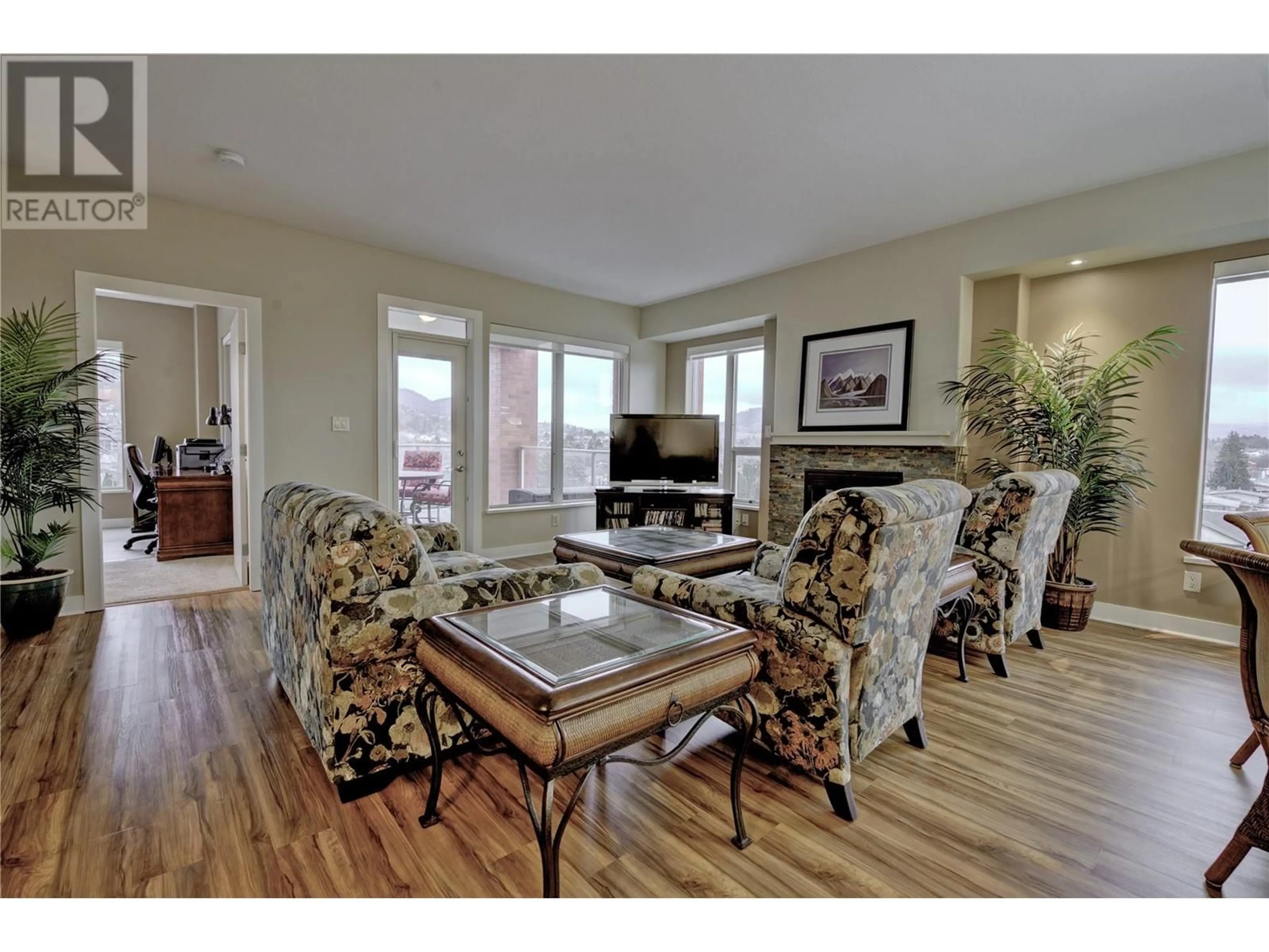 Living room with furniture, wood/laminate floor for 1160 Bernard Avenue Unit# 502, Kelowna British Columbia V1Y6R2