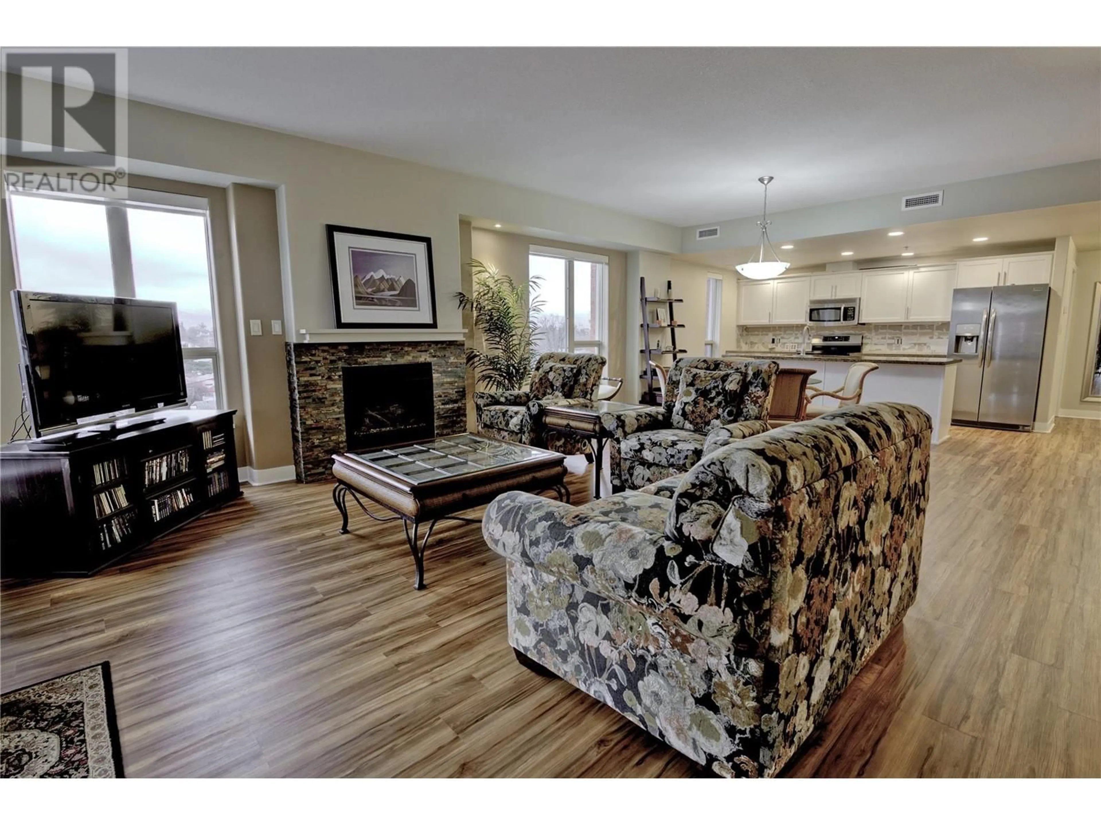 Living room with furniture, wood/laminate floor for 1160 Bernard Avenue Unit# 502, Kelowna British Columbia V1Y6R2