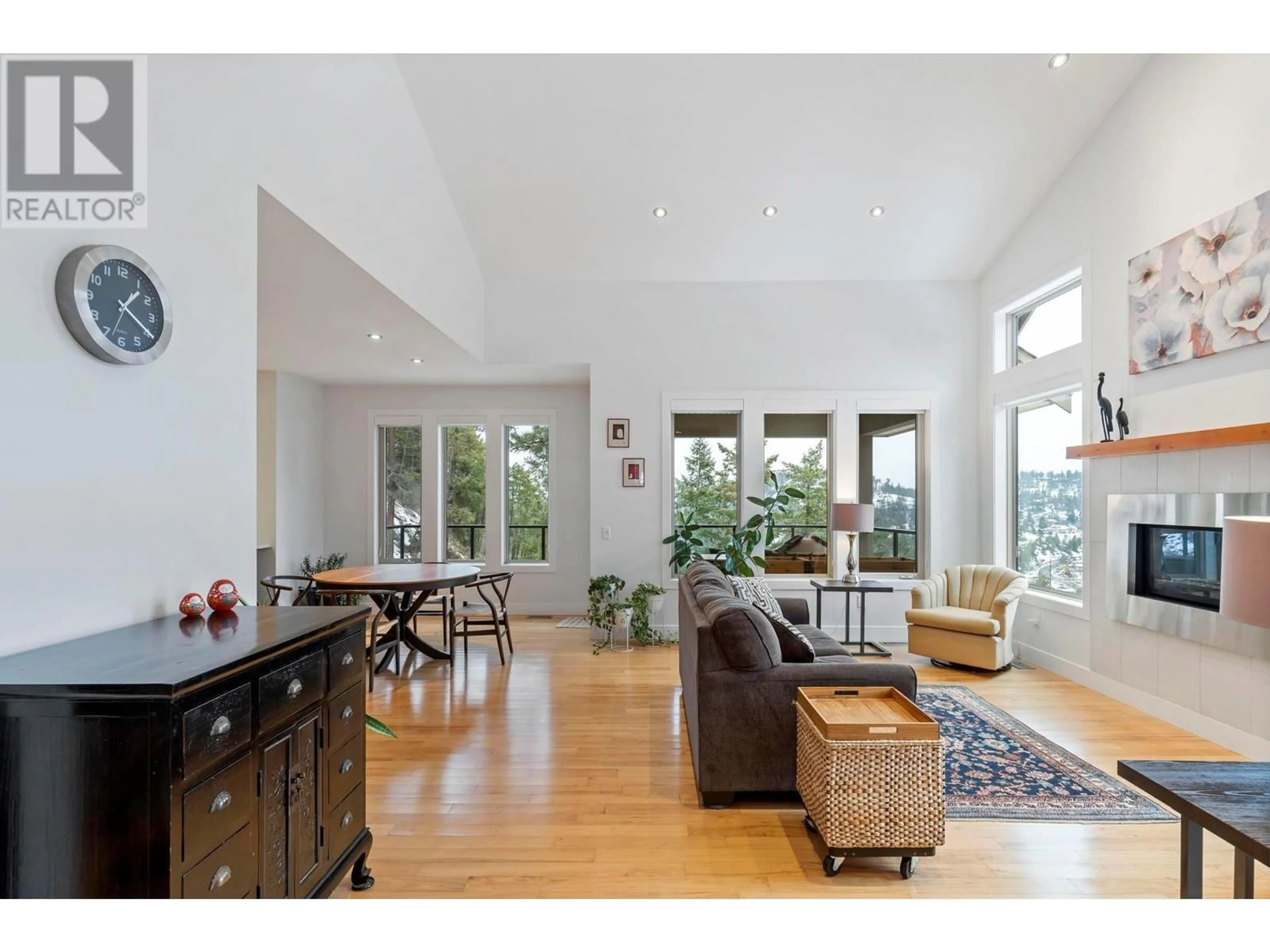 Living room with furniture, wood/laminate floor for 272 Triple Tree Place, Kelowna British Columbia V1V2Z8