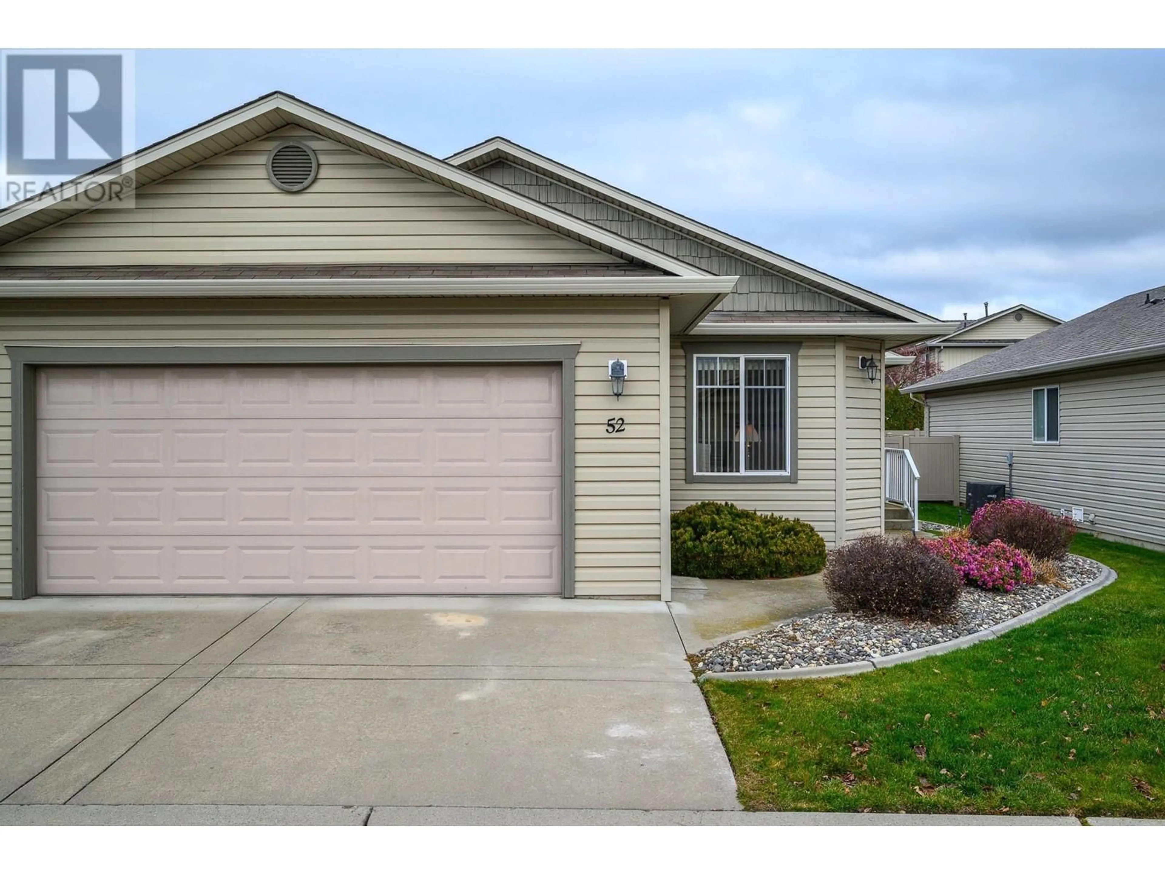 Home with vinyl exterior material, street for 5888 Okanagan Landing Road Unit# 52, Vernon British Columbia V1H1S2