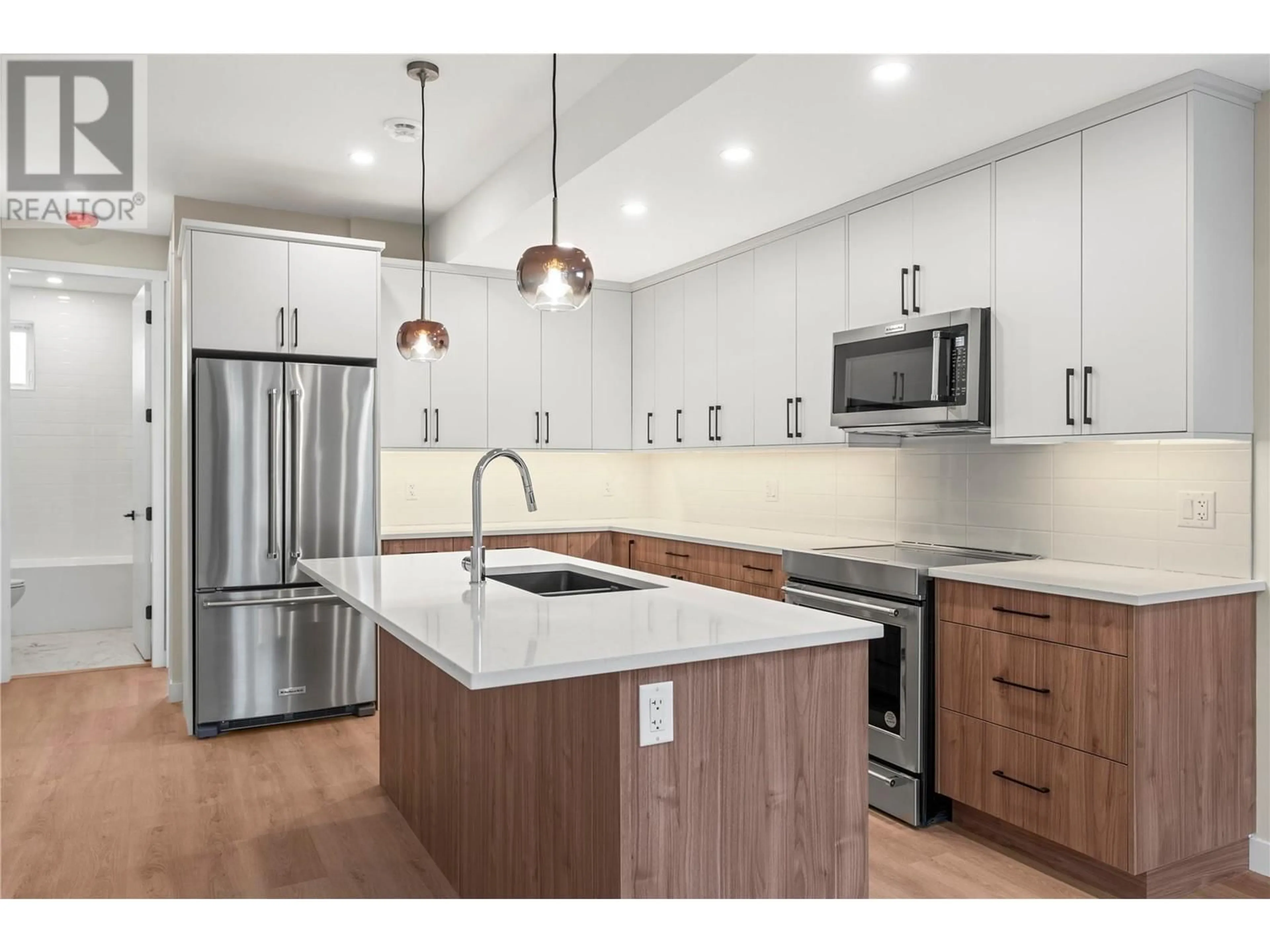Open concept kitchen, wood/laminate floor for 1 - 3907 26 STREET, Vernon British Columbia V1T4V5