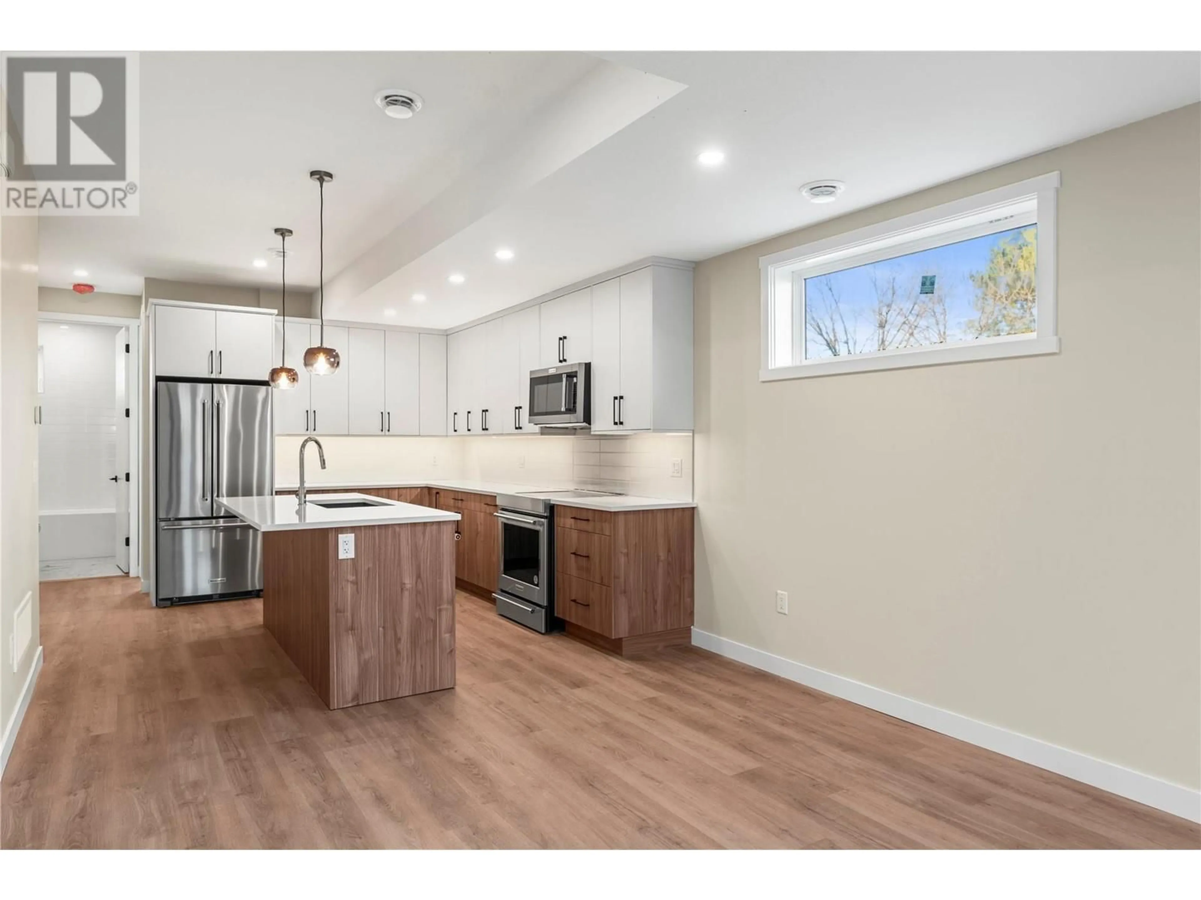 Open concept kitchen, wood/laminate floor for 1 - 3907 26 STREET, Vernon British Columbia V1T4V5