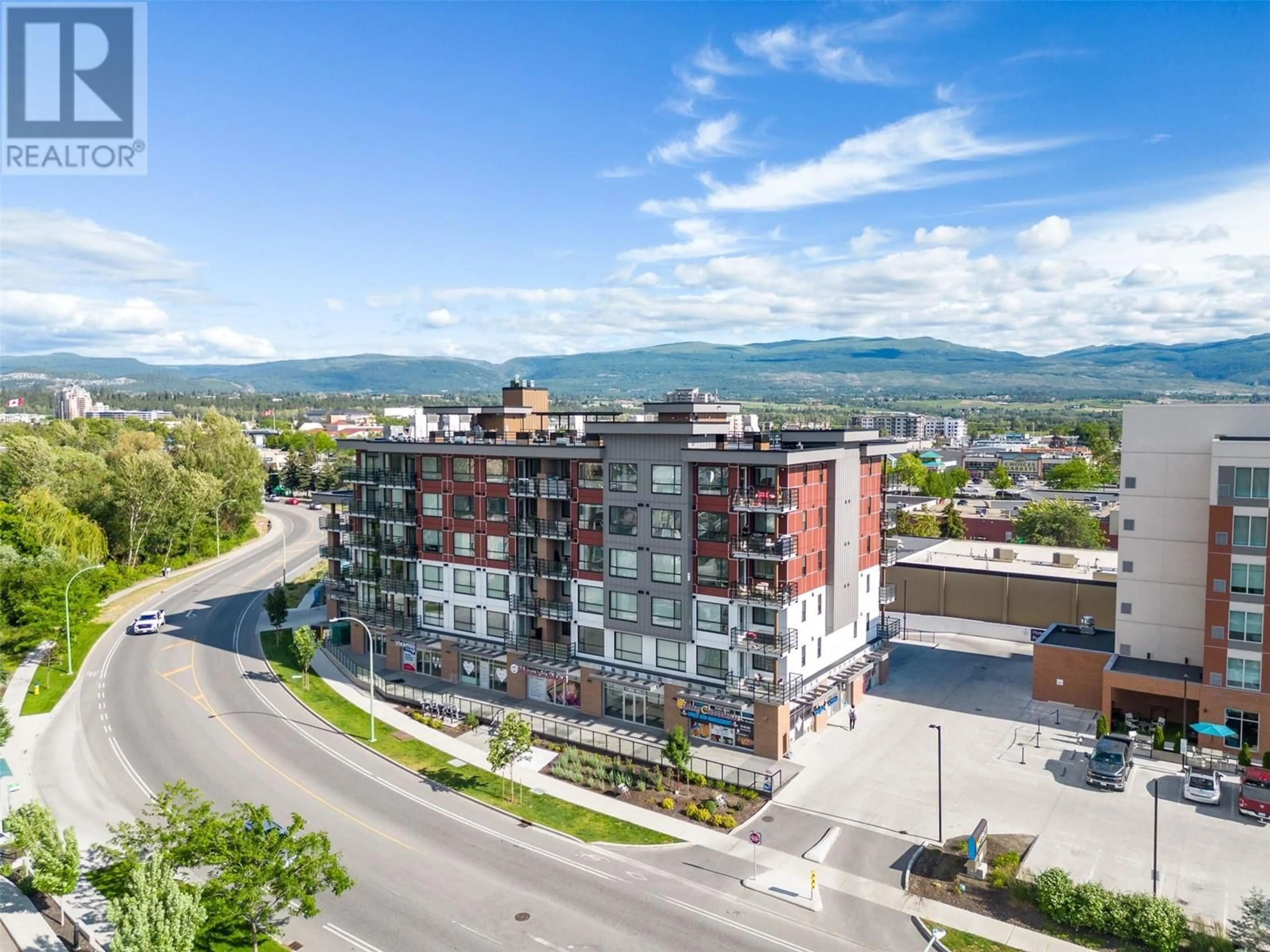 A pic from outside/outdoor area/front of a property/back of a property/a pic from drone, mountain view for 606 - 1925 ENTERPRISE WAY, Kelowna British Columbia V1Y9S9