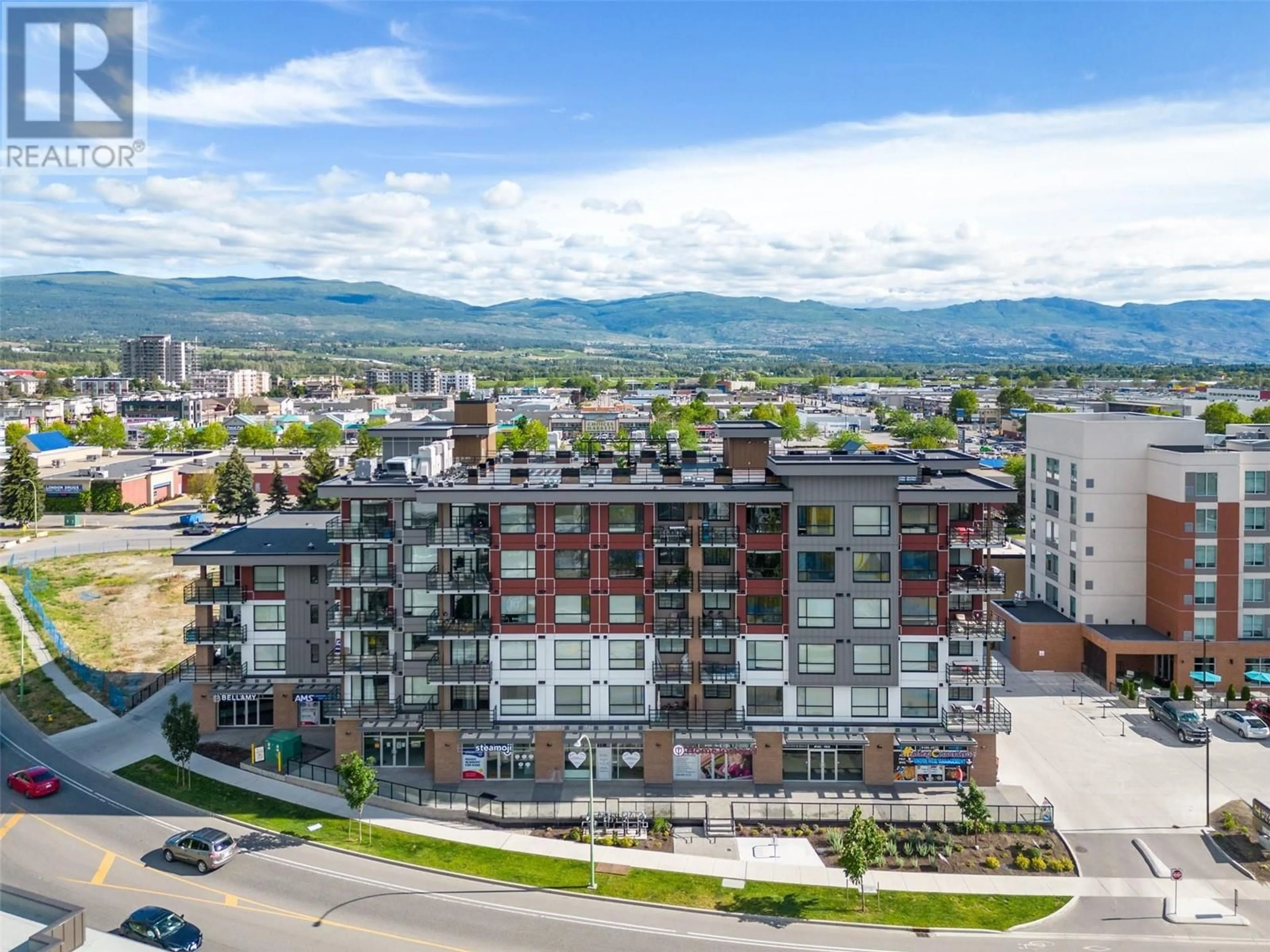 A pic from outside/outdoor area/front of a property/back of a property/a pic from drone, mountain view for 606 - 1925 ENTERPRISE WAY, Kelowna British Columbia V1Y9S9