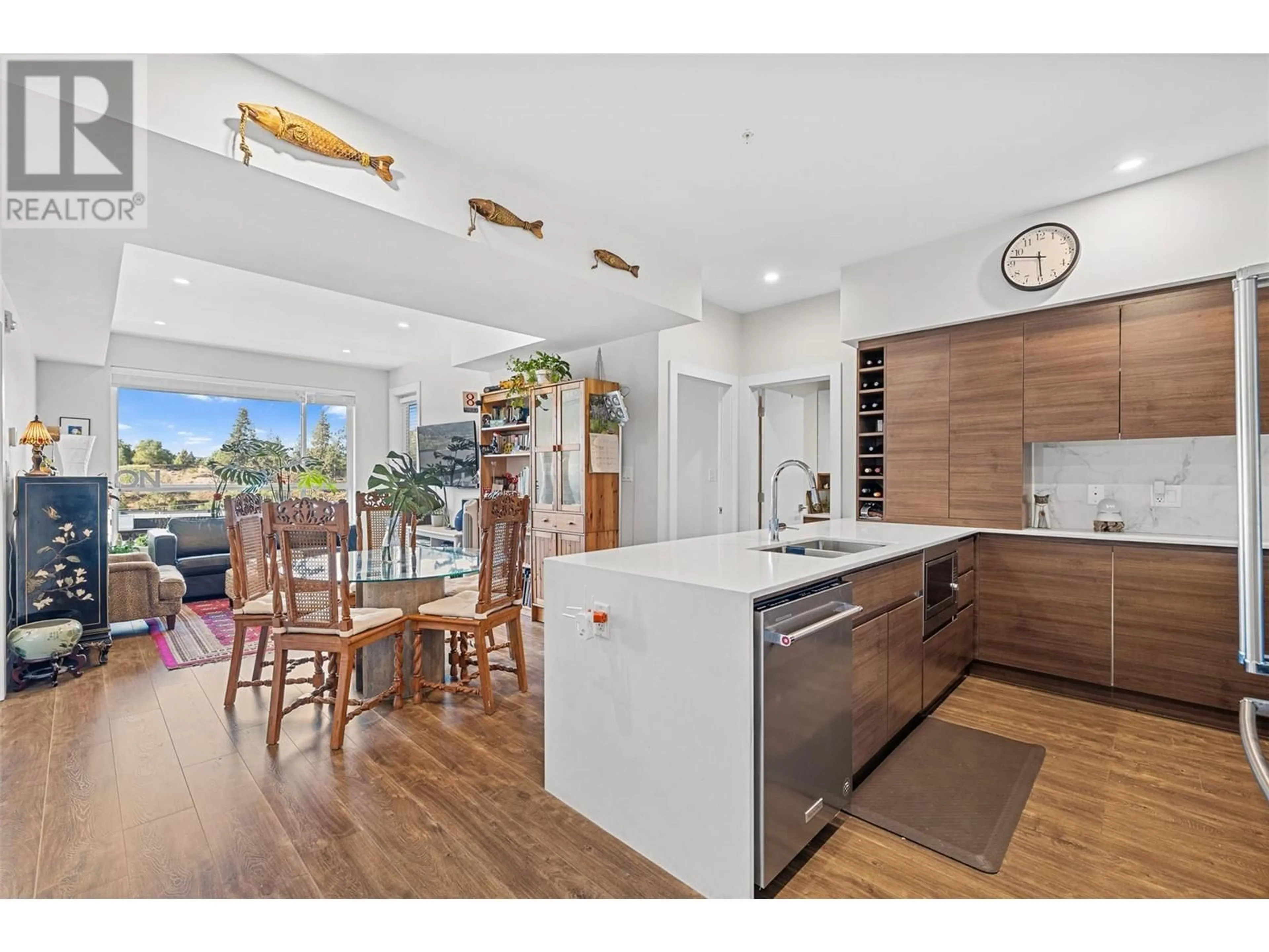Open concept kitchen, wood/laminate floor for 606 - 1925 ENTERPRISE WAY, Kelowna British Columbia V1Y9S9