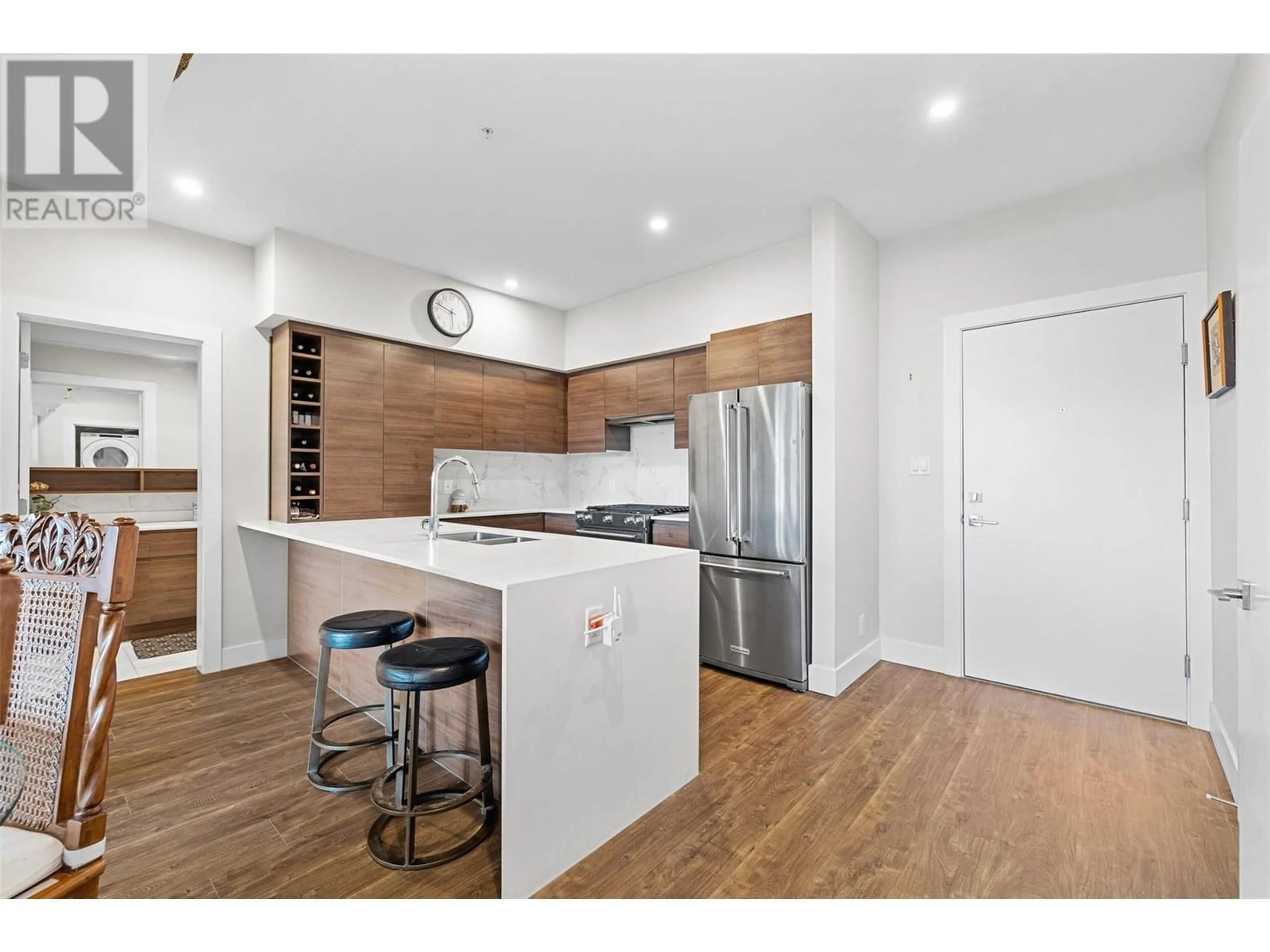 Open concept kitchen, wood/laminate floor for 606 - 1925 ENTERPRISE WAY, Kelowna British Columbia V1Y9S9