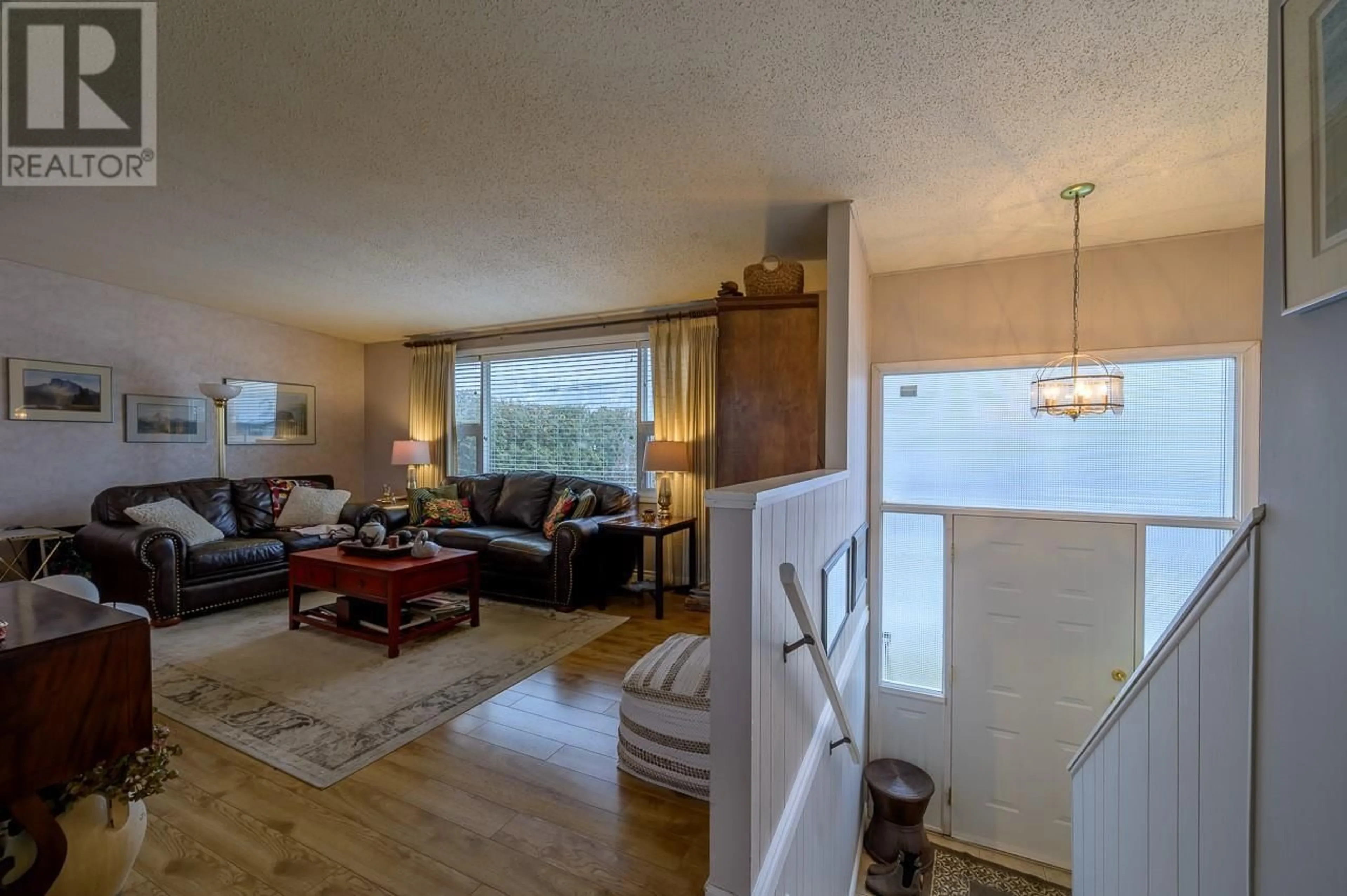 Living room with furniture, wood/laminate floor for 2543 Sandalwood Drive, Kamloops British Columbia V2B6V3