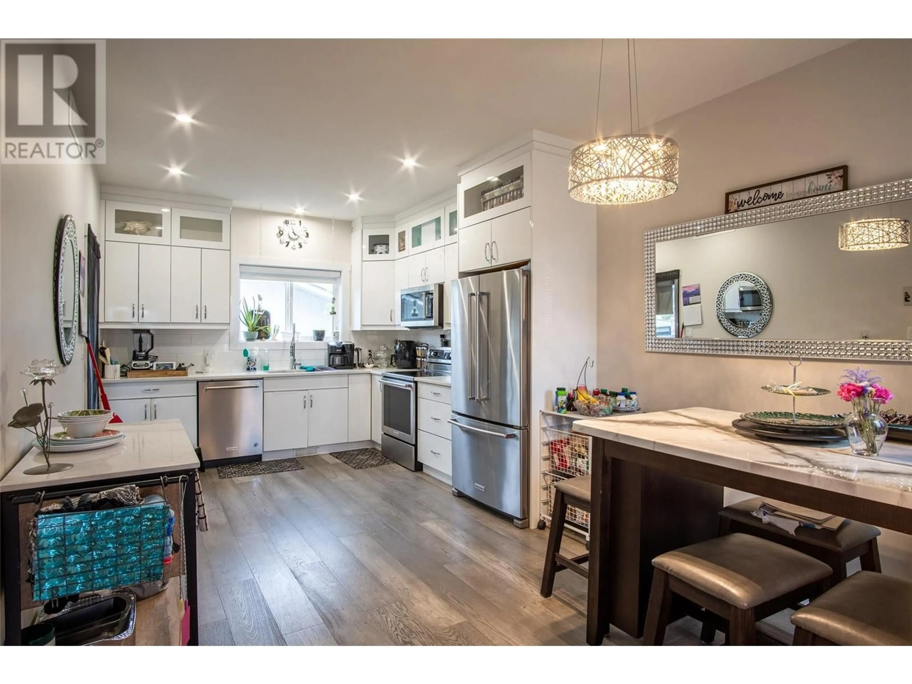 Open concept kitchen, wood/laminate floor for 136 Mugford Road, Kelowna British Columbia V1X2E3