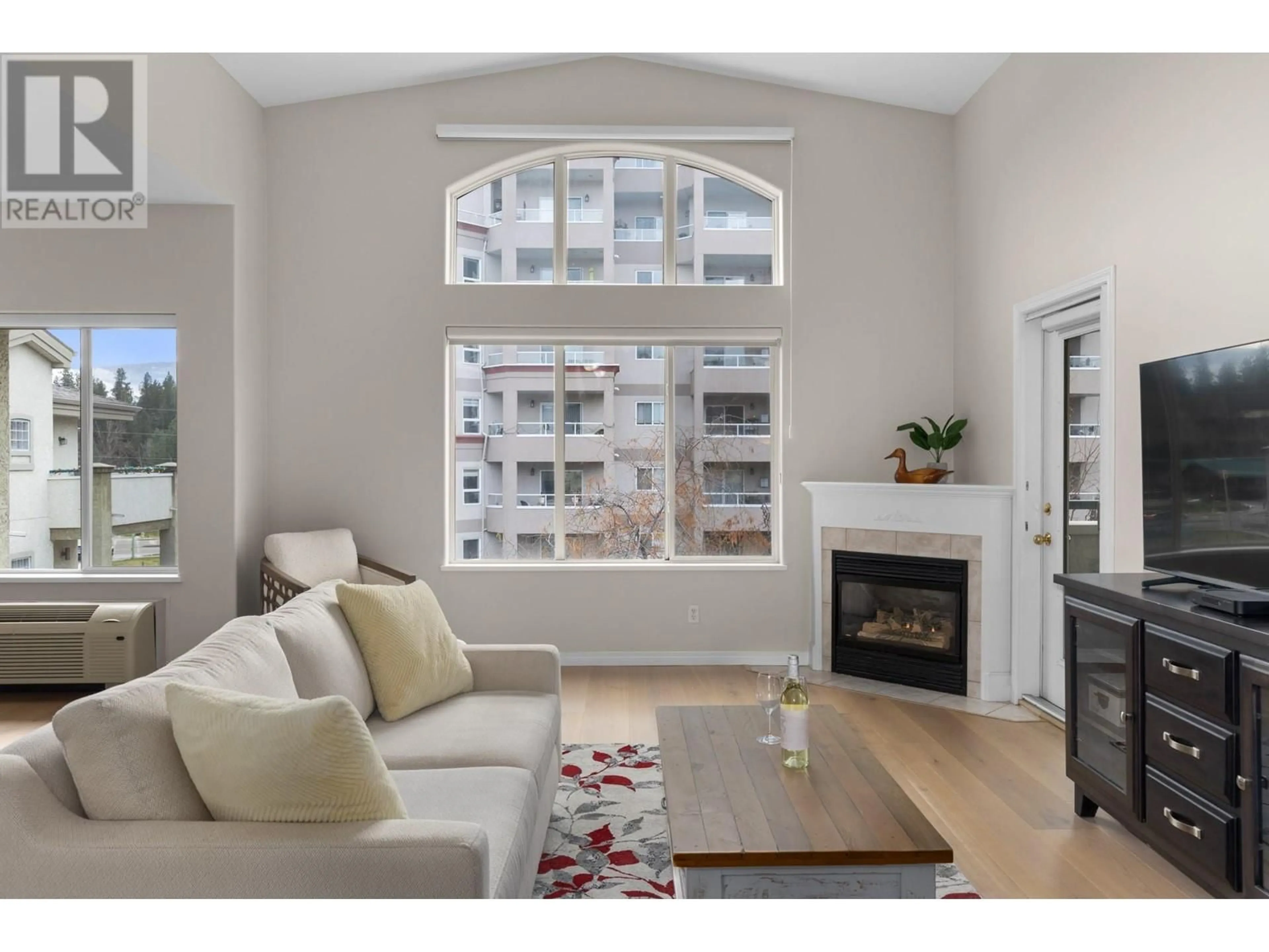 Living room with furniture, wood/laminate floor for 1950 Durnin Road Unit# 408, Kelowna British Columbia V1X7W6