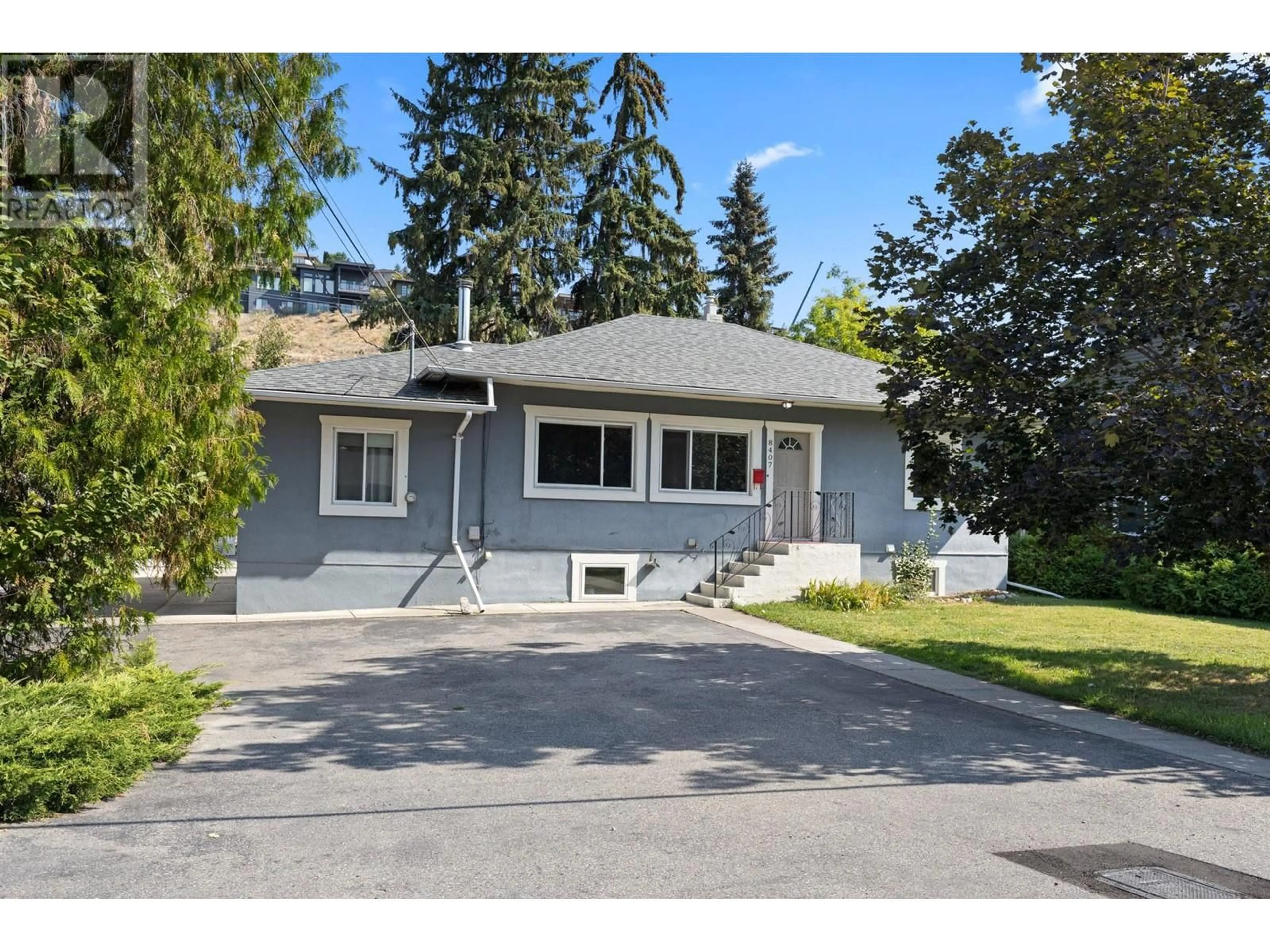 Home with vinyl exterior material, street for 8407 Postill Drive, Coldstream British Columbia V1B1T9