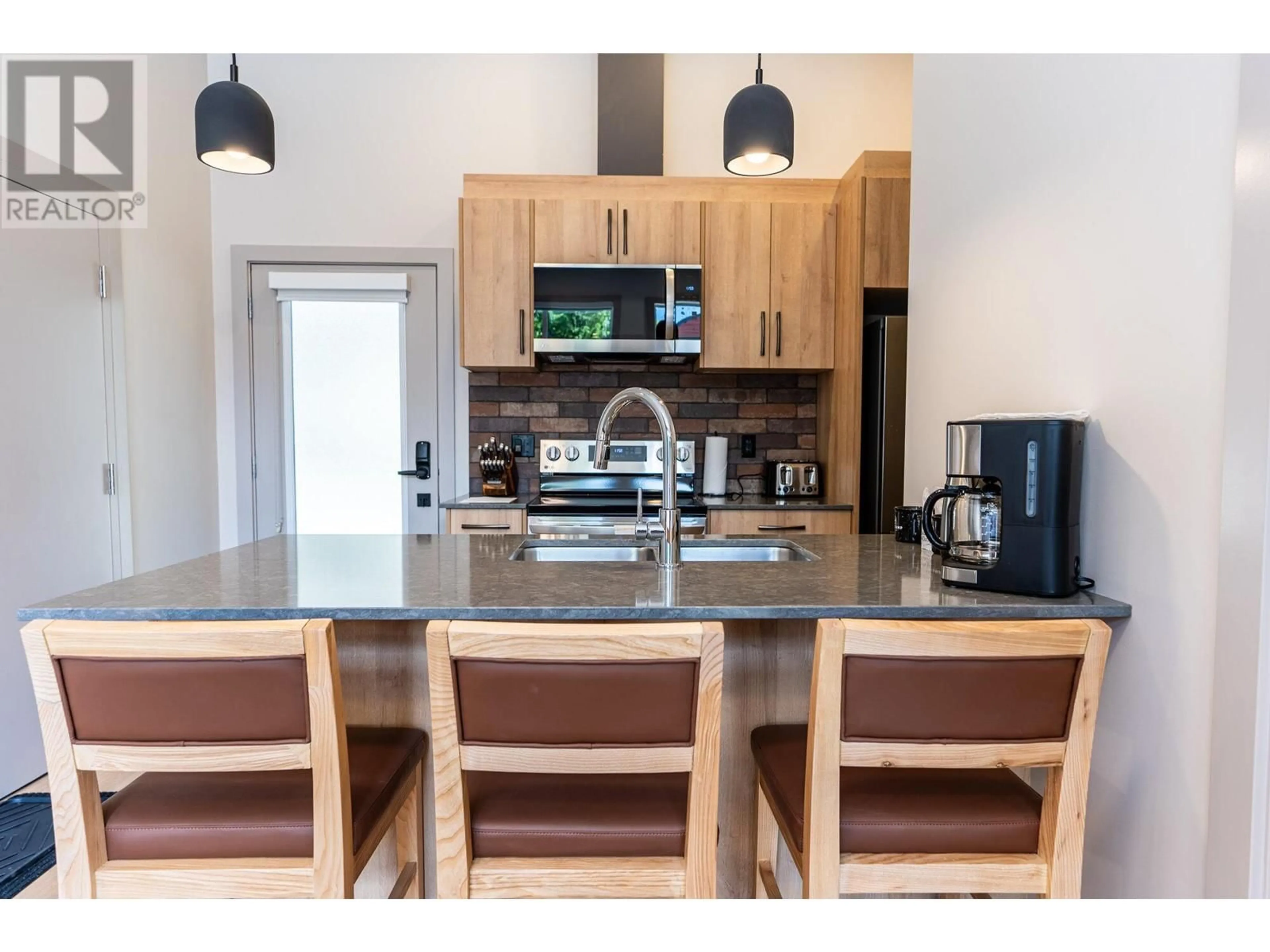 Open concept kitchen, wood/laminate floor for 112 Second Street E Unit# 104, Revelstoke British Columbia V0E2S0