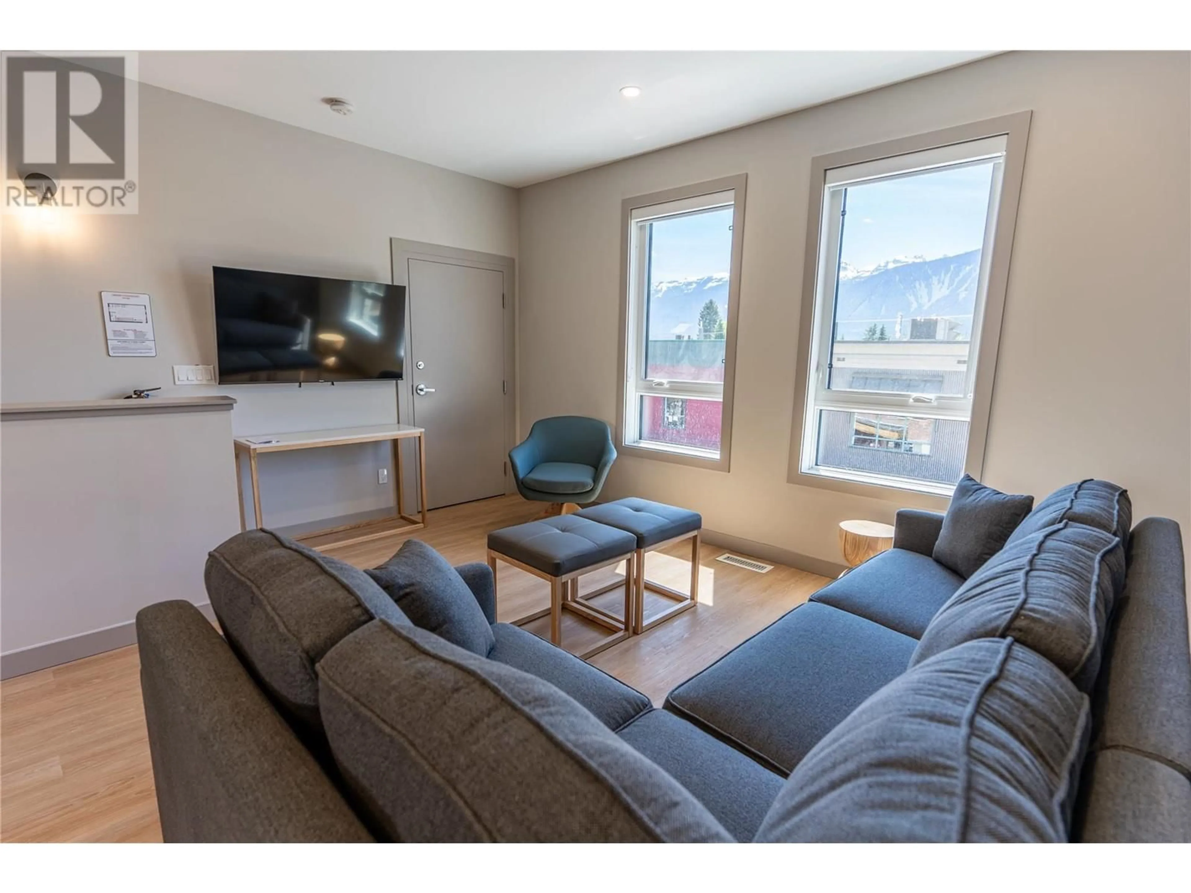 Living room with furniture, wood/laminate floor for 112 Second Street E Unit# 203, Revelstoke British Columbia V0E2S0