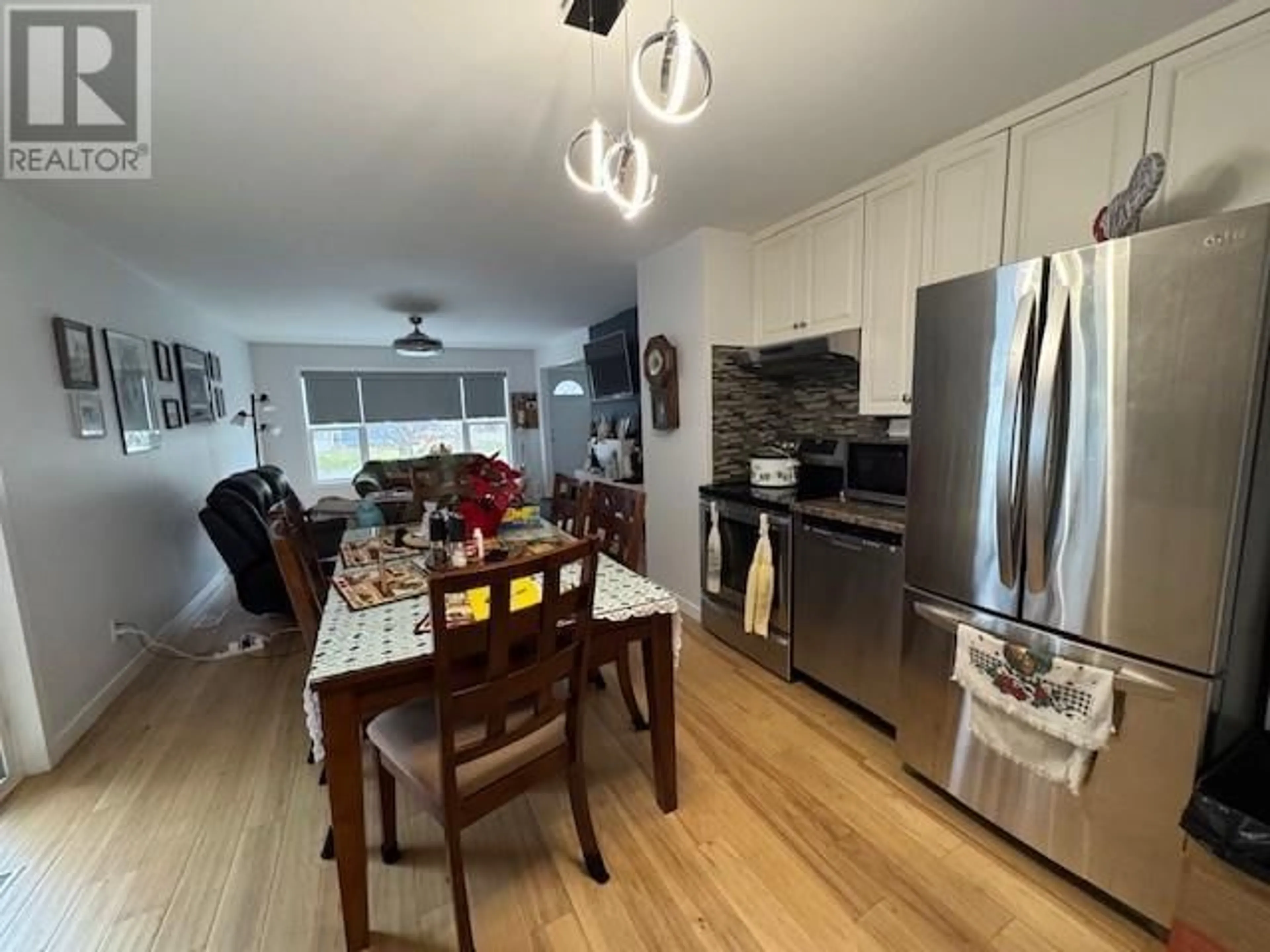 Open concept kitchen, wood/laminate floor for 2127 Cedar Street, Creston British Columbia V0B1G5