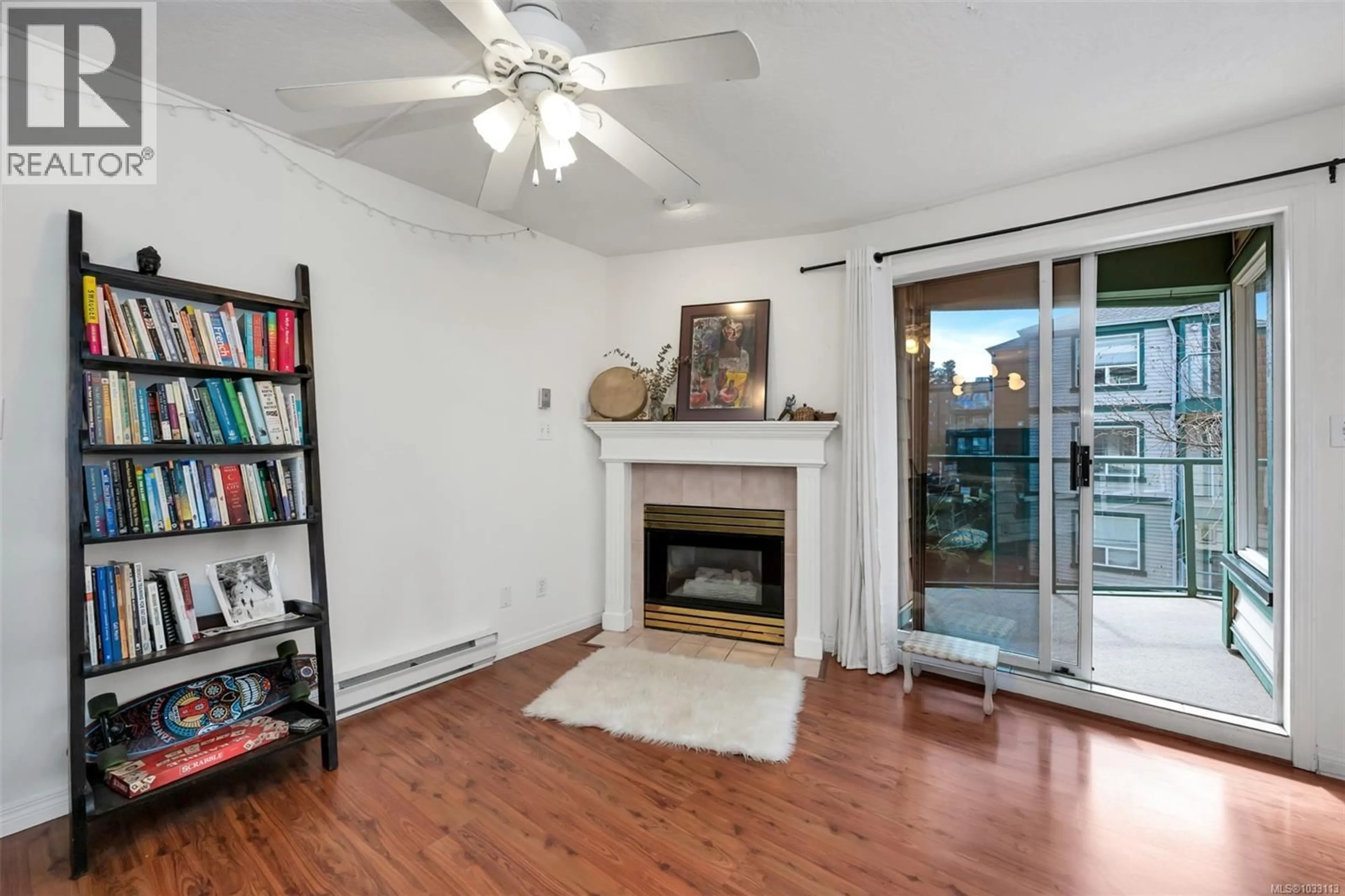 Living room with furniture, wood/laminate floor for 212 - 899 DARWIN AVENUE, Saanich British Columbia V8X2X7