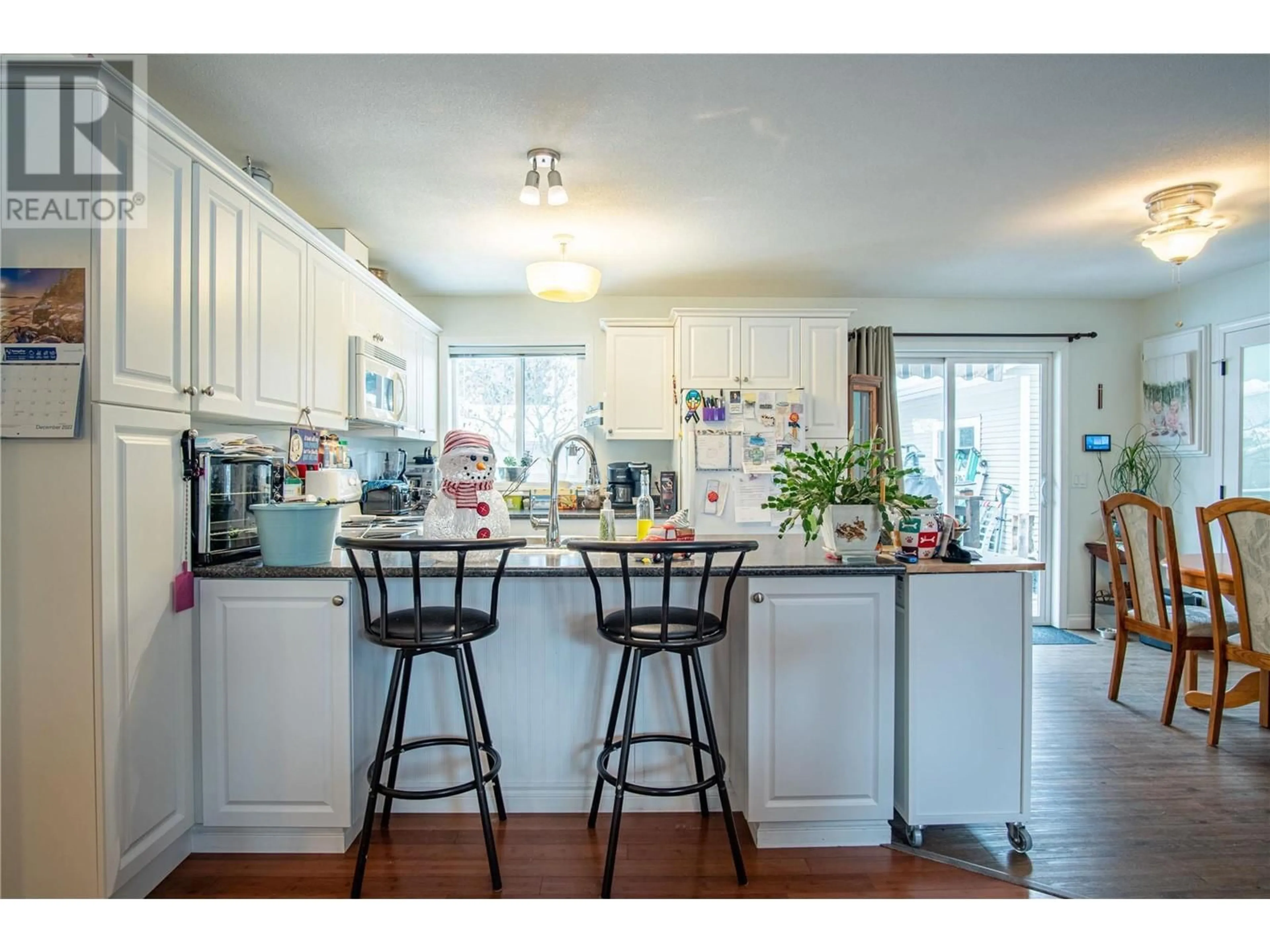 Open concept kitchen, wood/laminate floor for 3755 Glover Avenue, Armstrong British Columbia V0E1B4