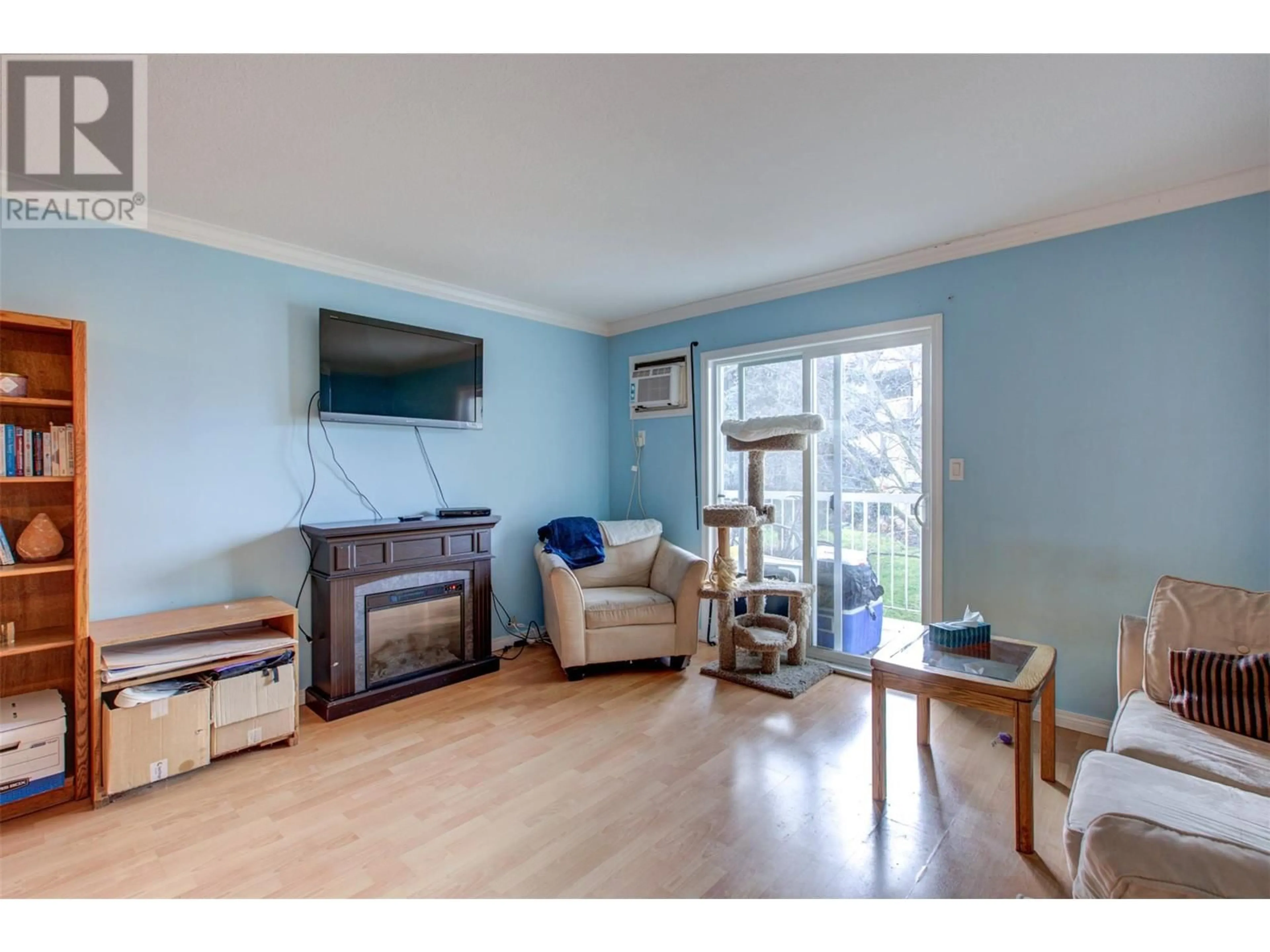 Living room with furniture, wood/laminate floor for 735 Cook Road Unit# 206D, Kelowna British Columbia V1W3G6