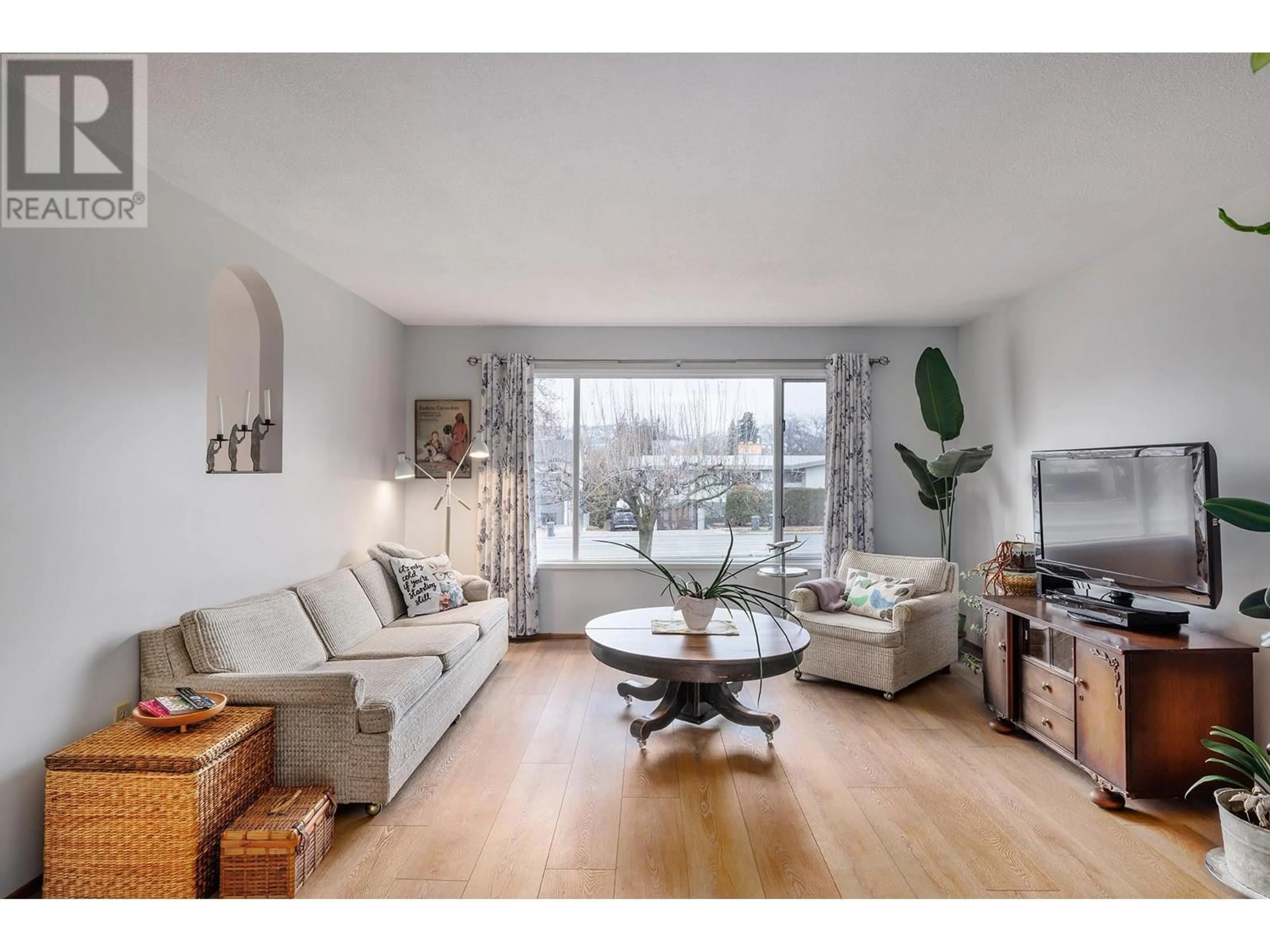 Living room with furniture, wood/laminate floor for 1347 Springfield Road, Kelowna British Columbia V1Y5V2