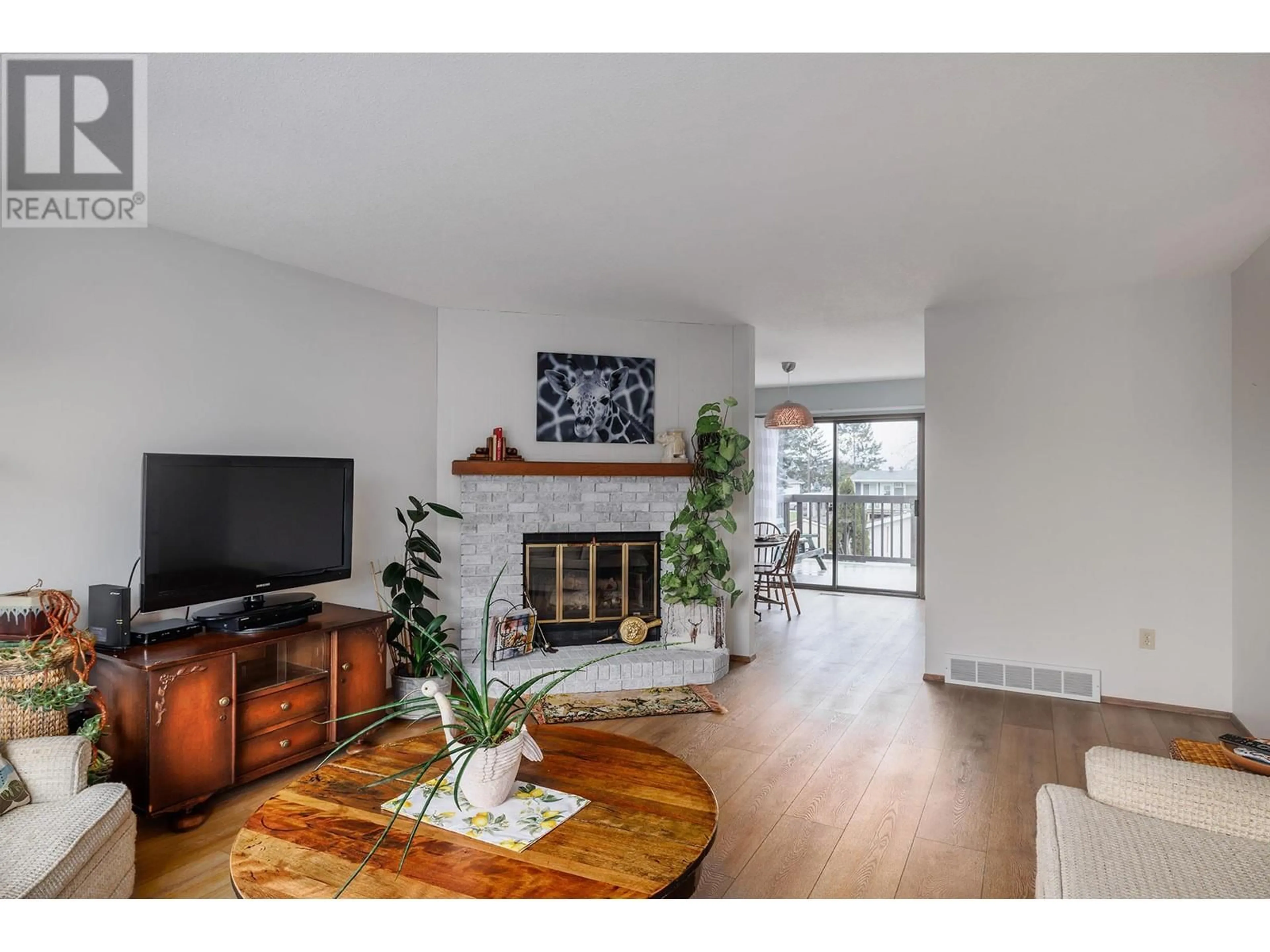 Living room with furniture, wood/laminate floor for 1347 Springfield Road, Kelowna British Columbia V1Y5V2