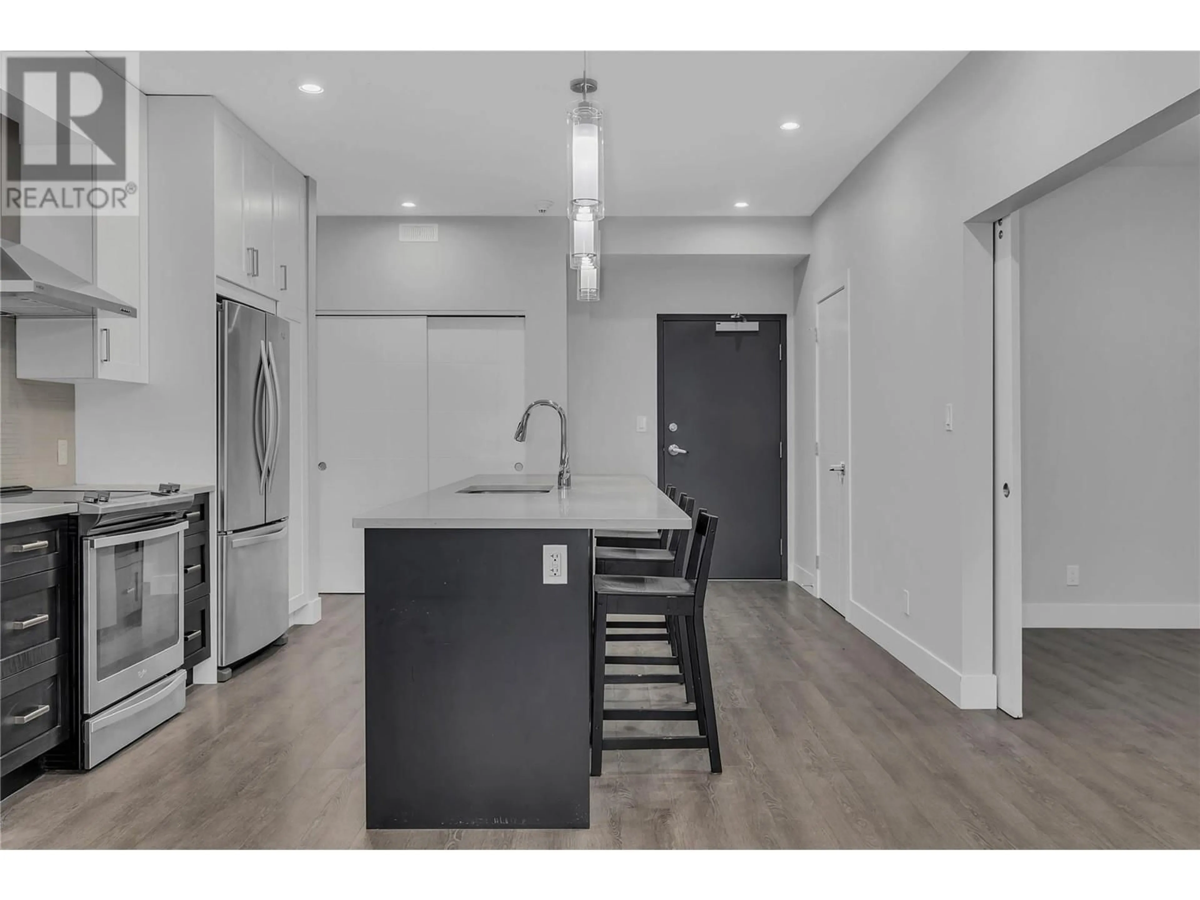 Open concept kitchen, wood/laminate floor for 4215 Gellatly Road S Unit# 1202, West Kelowna British Columbia V4T2K3