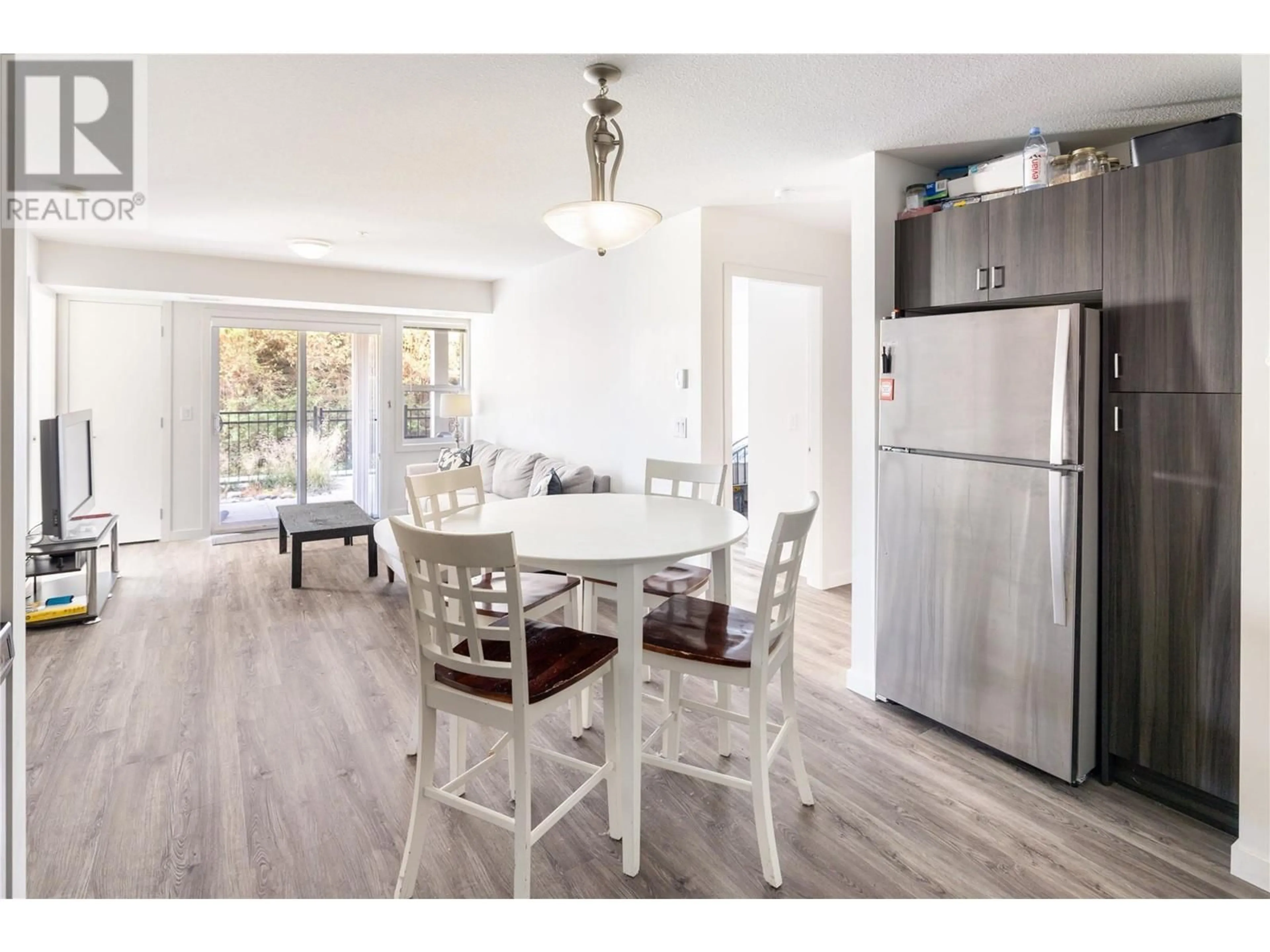 Open concept kitchen, wood/laminate floor for 107 - 655 ACADEMY WAY, Kelowna British Columbia V1V0C8
