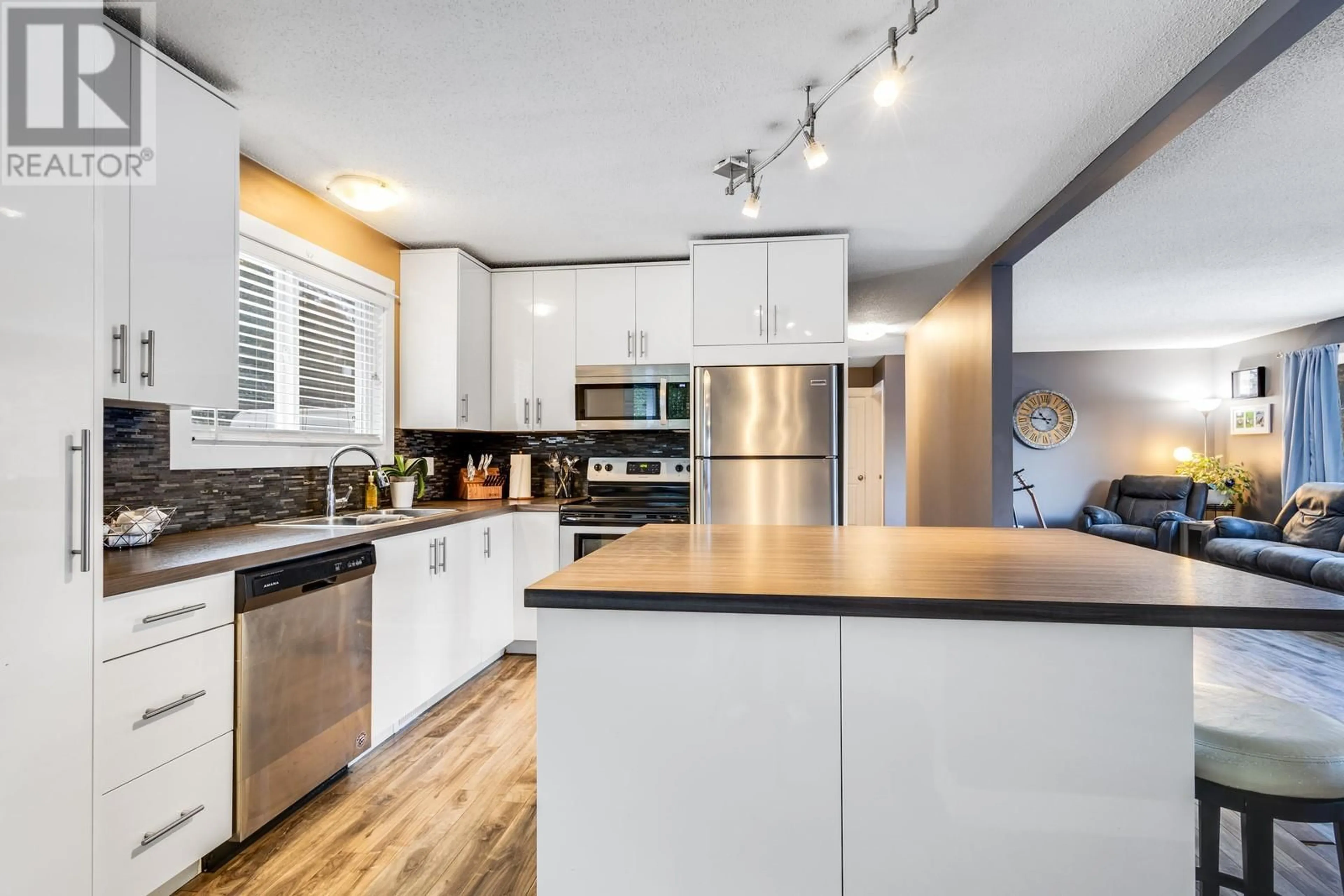 Open concept kitchen, wood/laminate floor for 1324 Ponderosa Road, West Kelowna British Columbia V1Z1M7