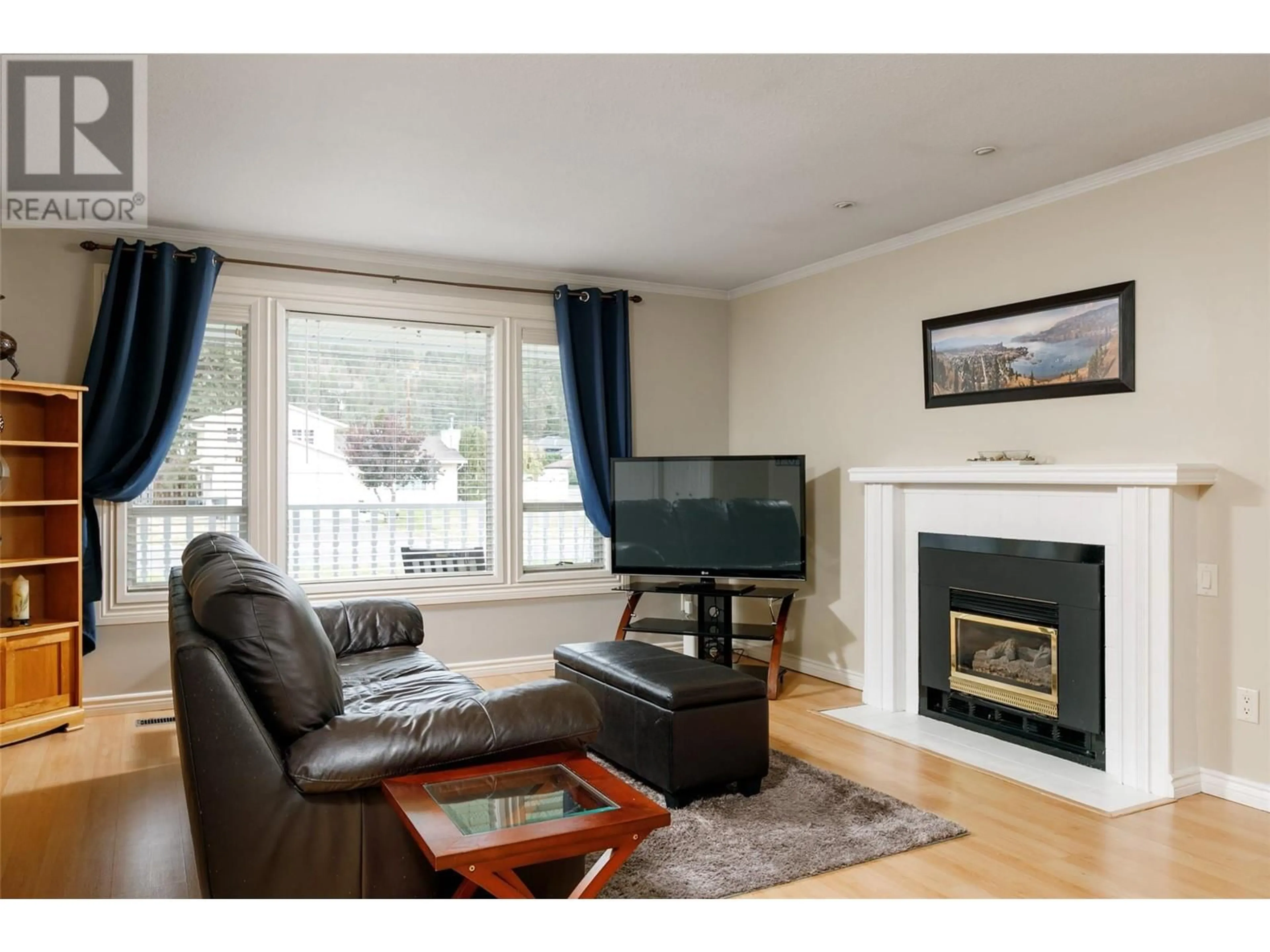 Living room with furniture, wood/laminate floor for 3172 Webber Road, West Kelowna British Columbia V4T1E7