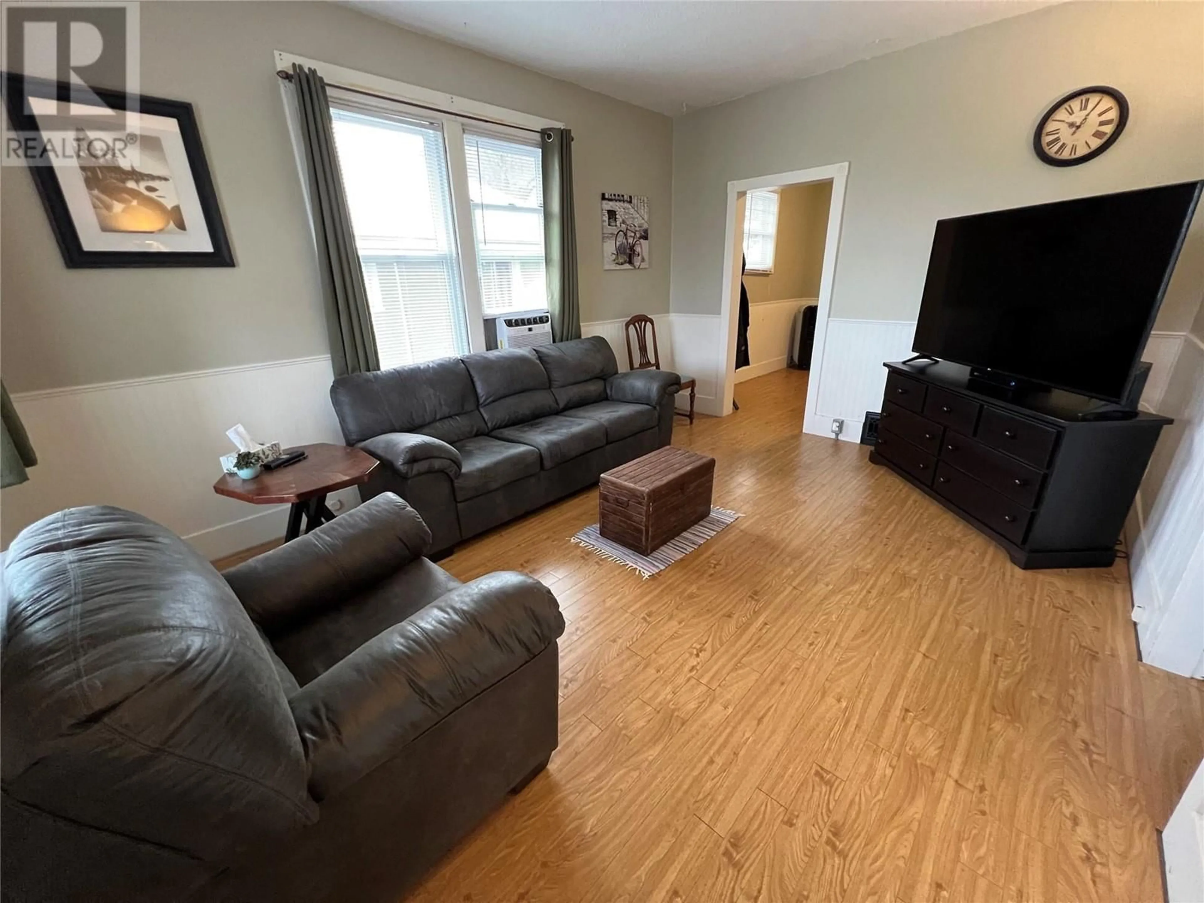 Living room with furniture, wood/laminate floor for 396 Buckna Street, Trail British Columbia V1R3K3