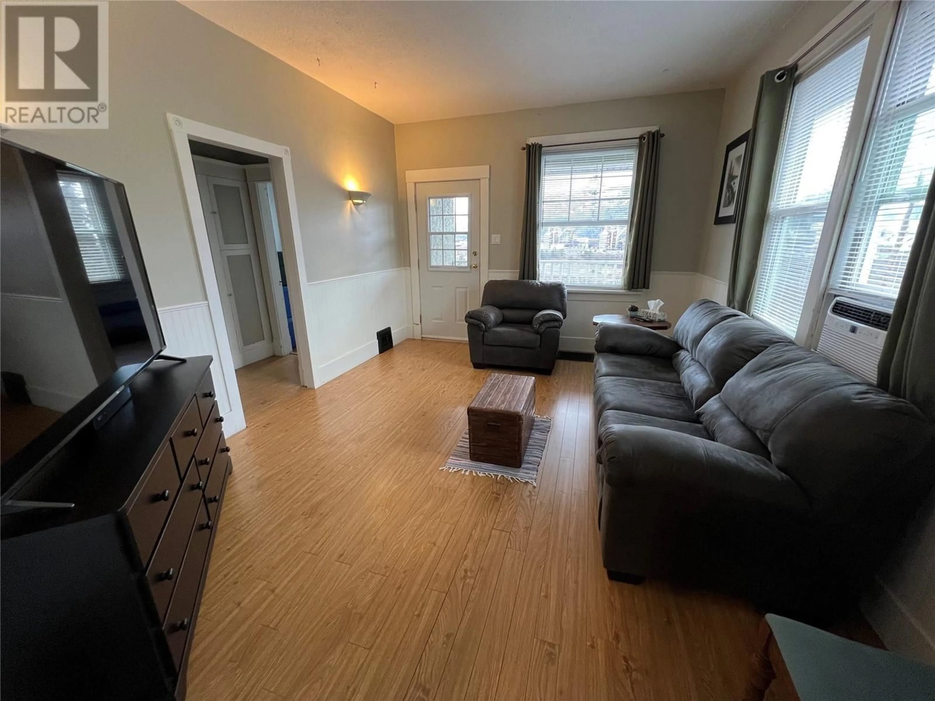 Living room with furniture, wood/laminate floor for 396 Buckna Street, Trail British Columbia V1R3K3