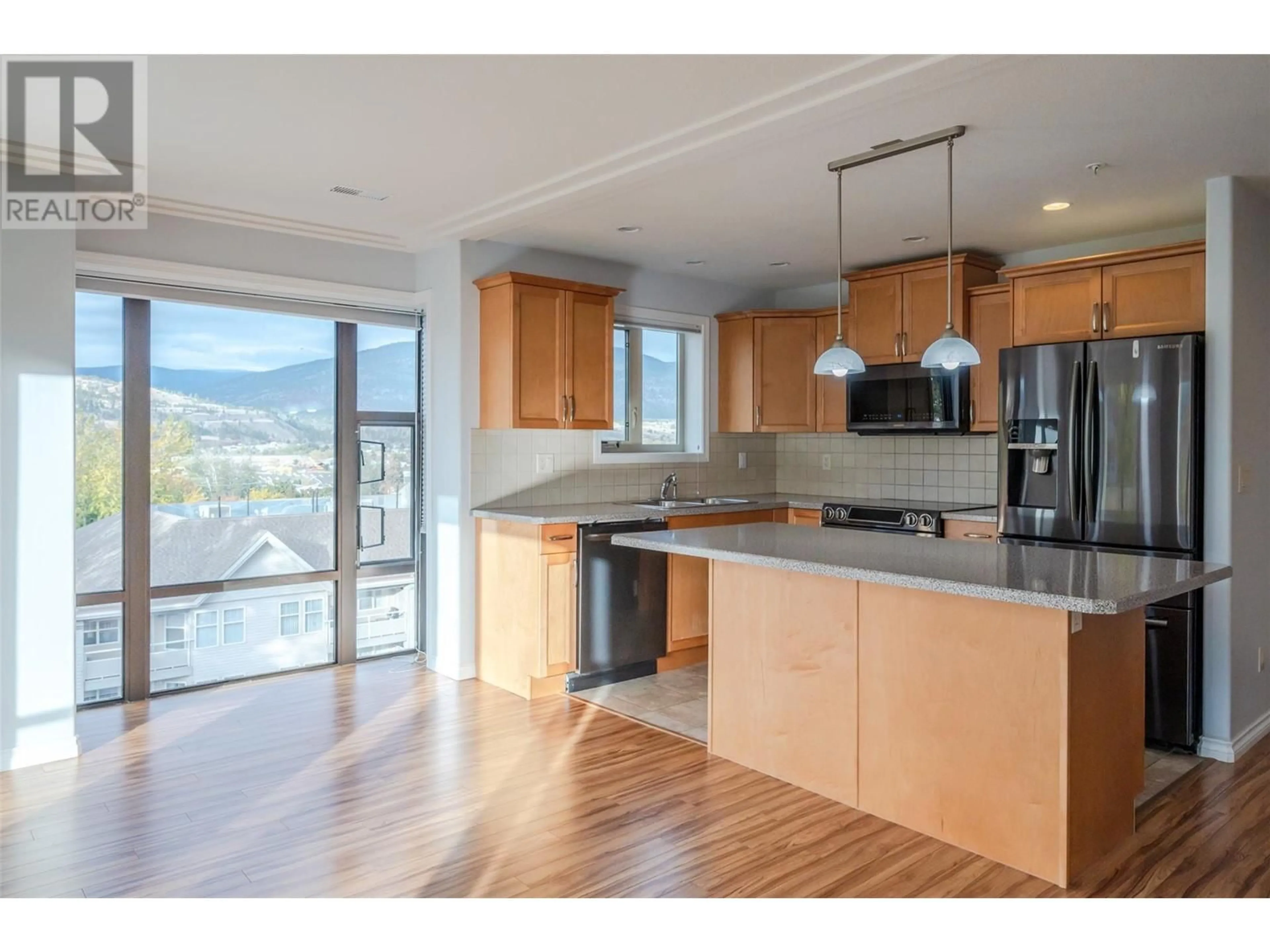 Open concept kitchen, wood/laminate floor for 2125 Atkinson Street Unit# 605, Penticton British Columbia V2A9E6