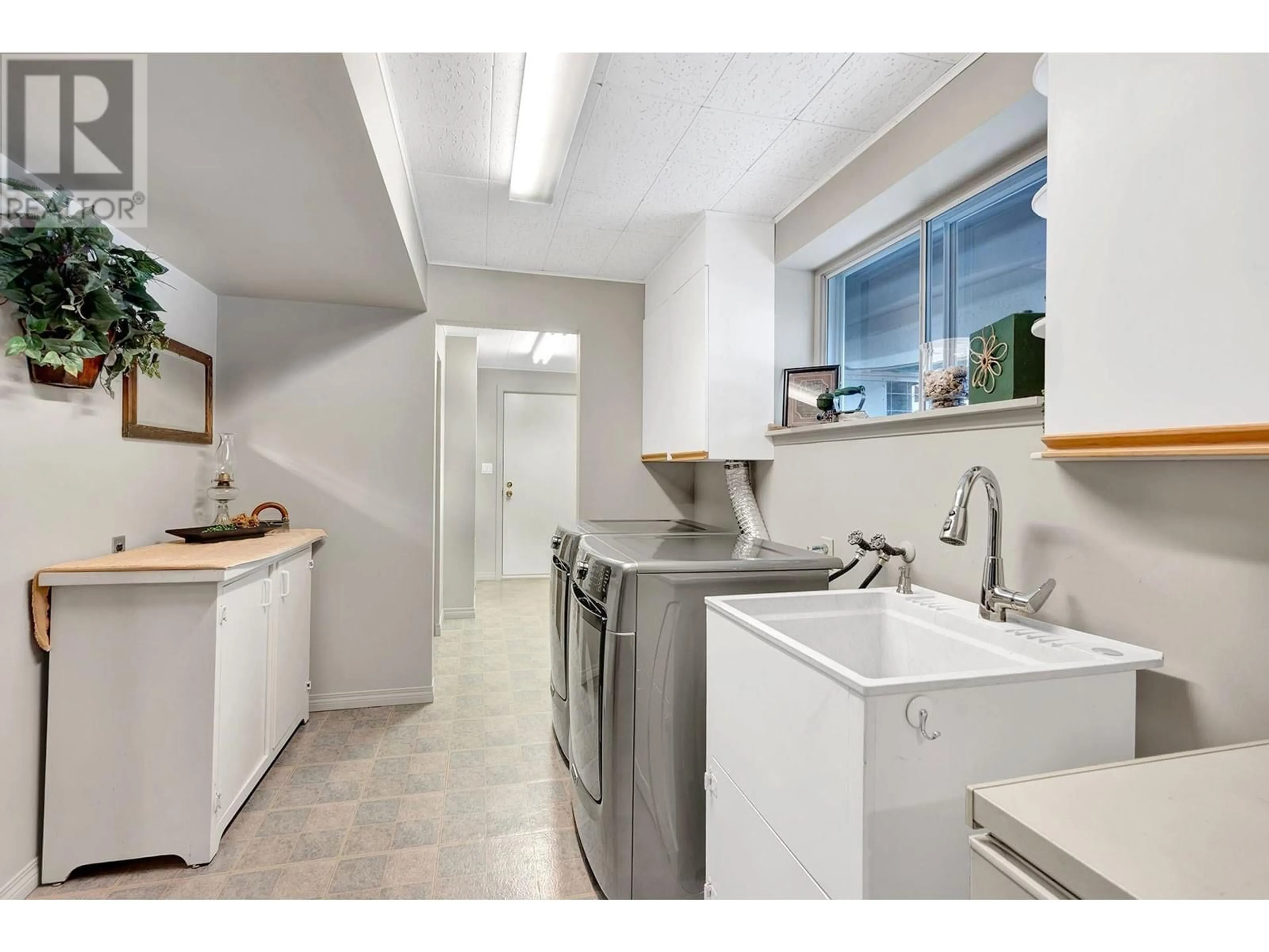 Kitchen with laundary machines, ceramic/tile floor for 6277 CHUKAR Drive, Kamloops British Columbia V2C4T6