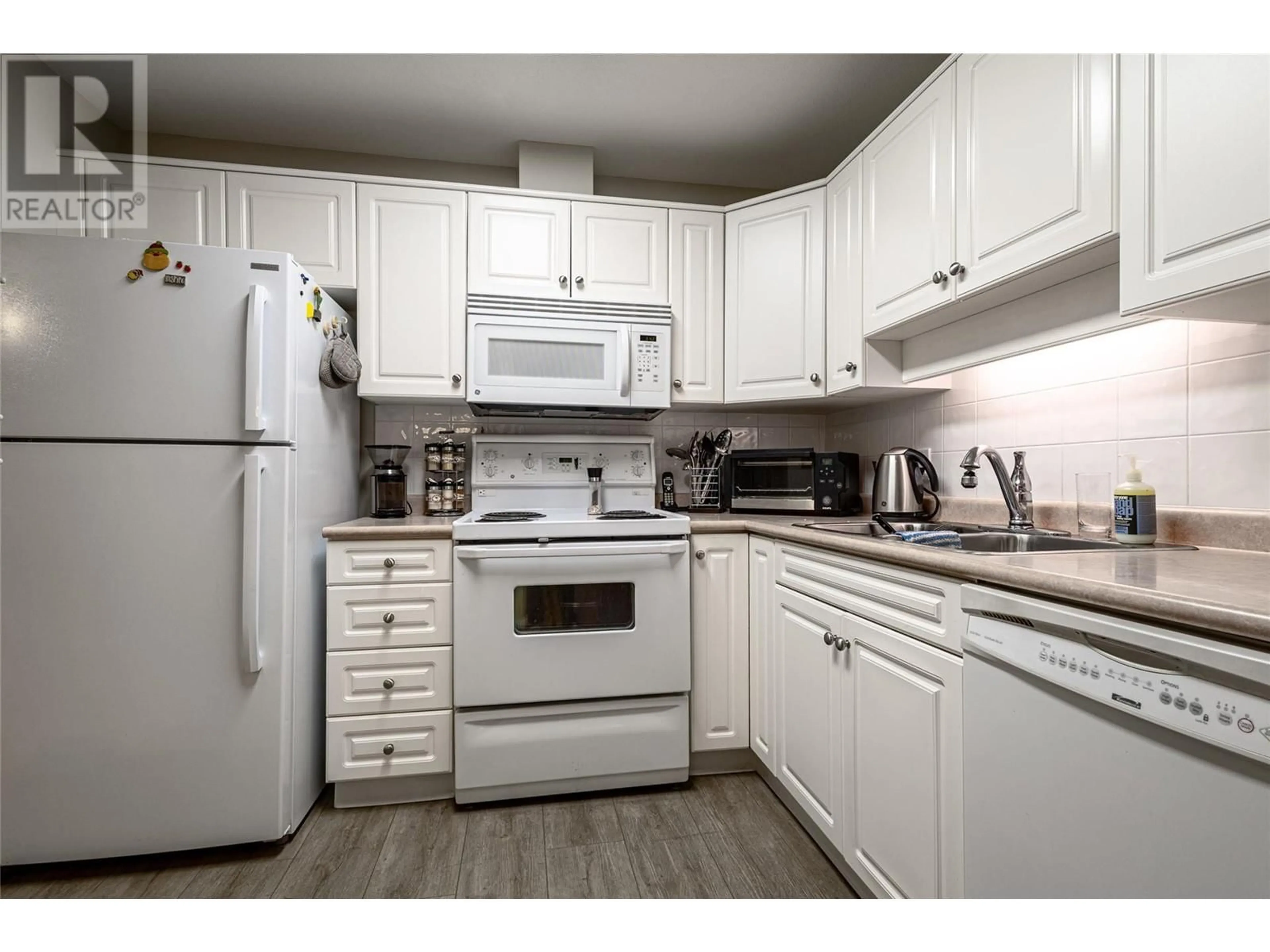 Standard kitchen, wood/laminate floor for 1966 Enterprise Way Unit# 412, Kelowna British Columbia V1Y9S8