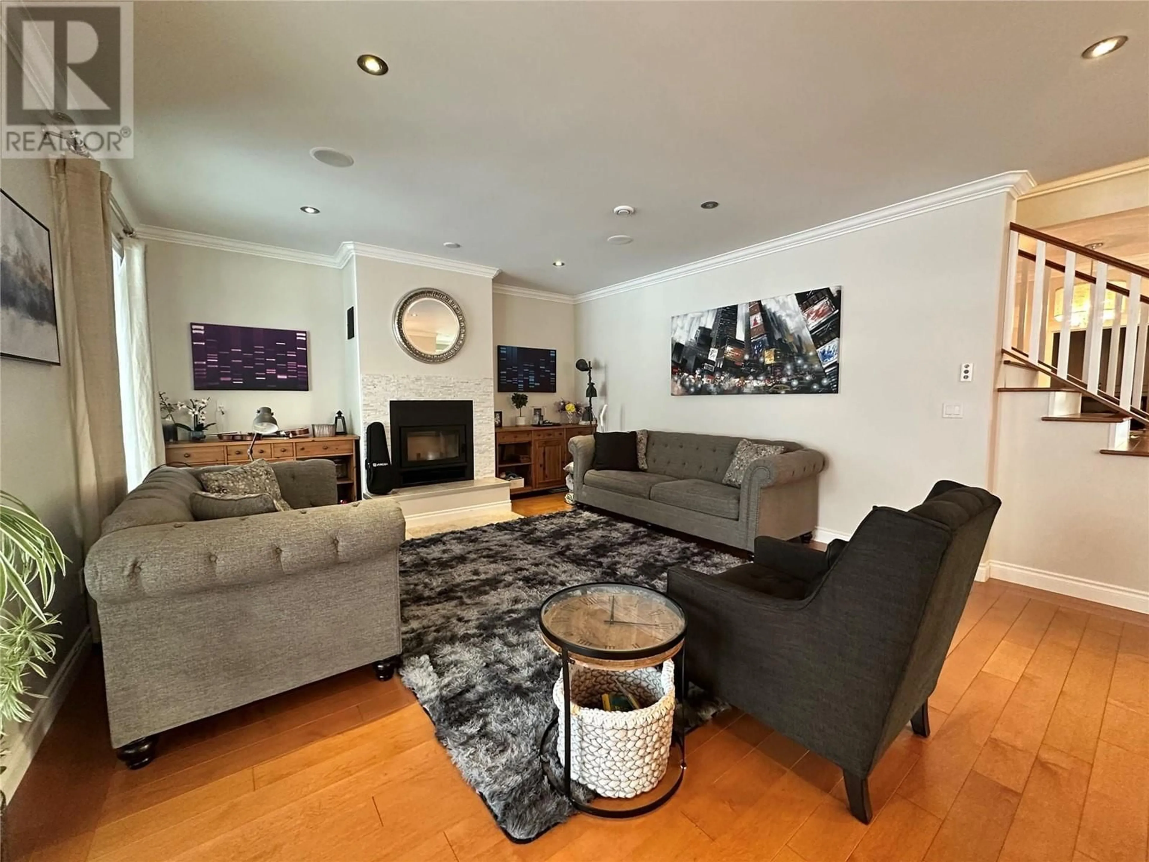 Living room with furniture, wood/laminate floor for 9109 Forest Park Drive, Dawson Creek British Columbia V1G4Z4