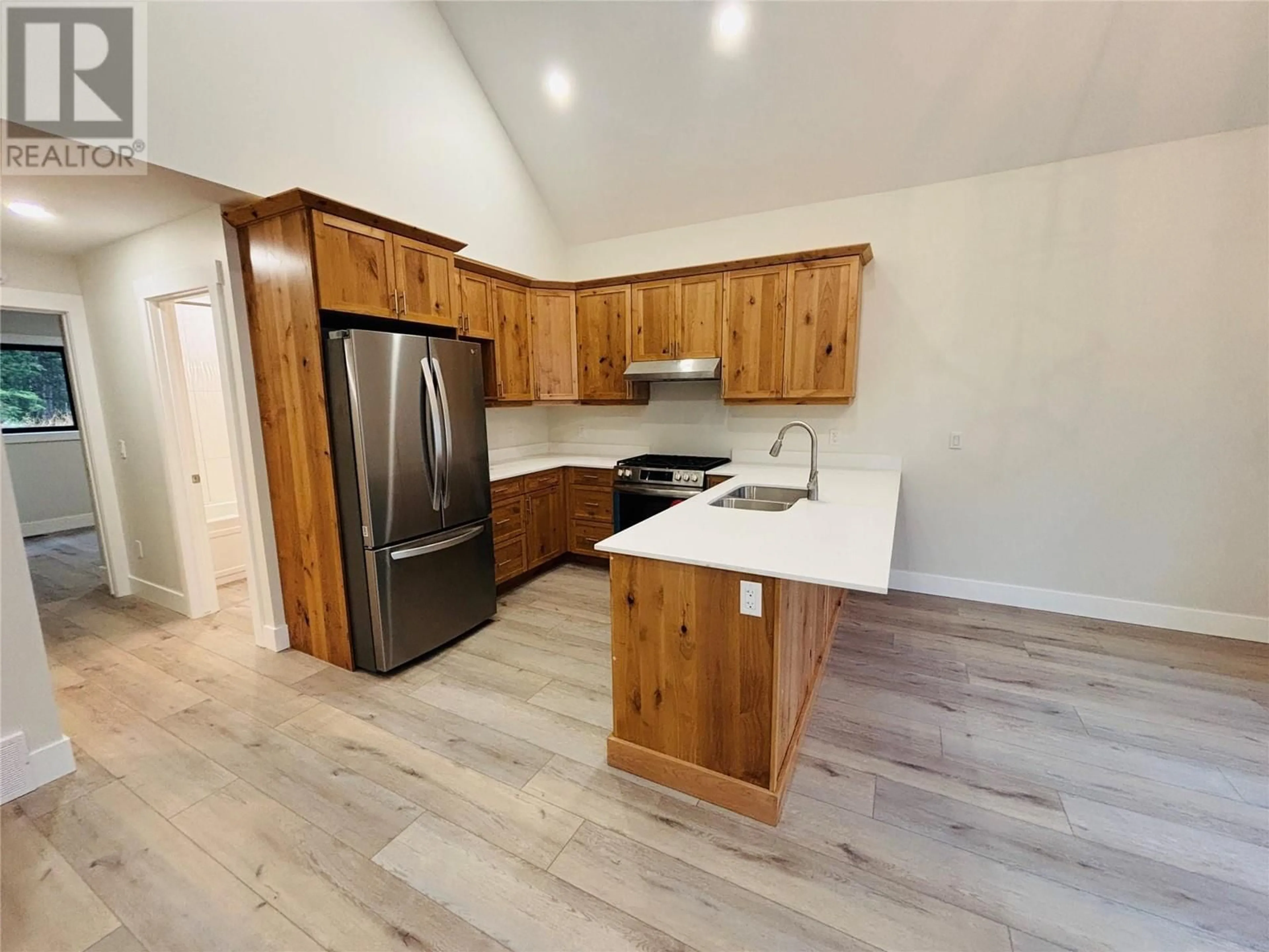 Open concept kitchen, wood/laminate floor for 1938 FOXWOOD Trail Unit# 4, Windermere British Columbia V0B2L2