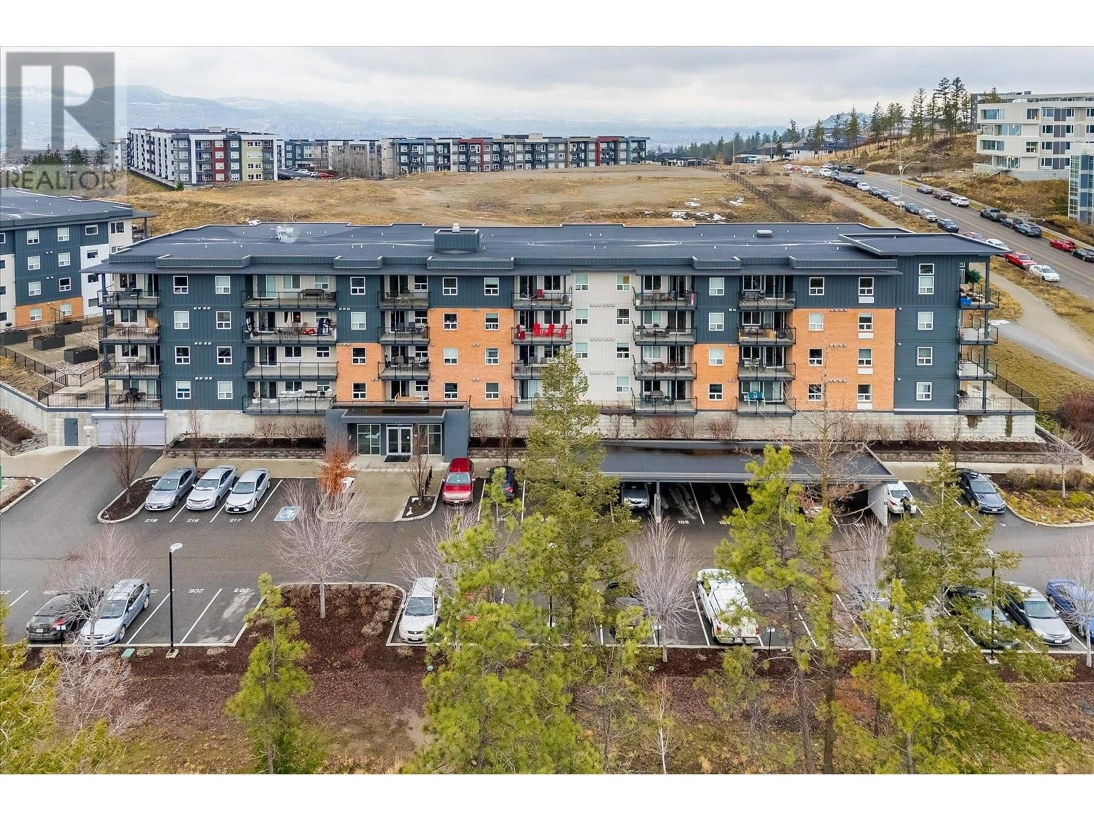 A pic from outside/outdoor area/front of a property/back of a property/a pic from drone, unknown for 881 Academy Way Unit# 316, Kelowna British Columbia V1V0A3