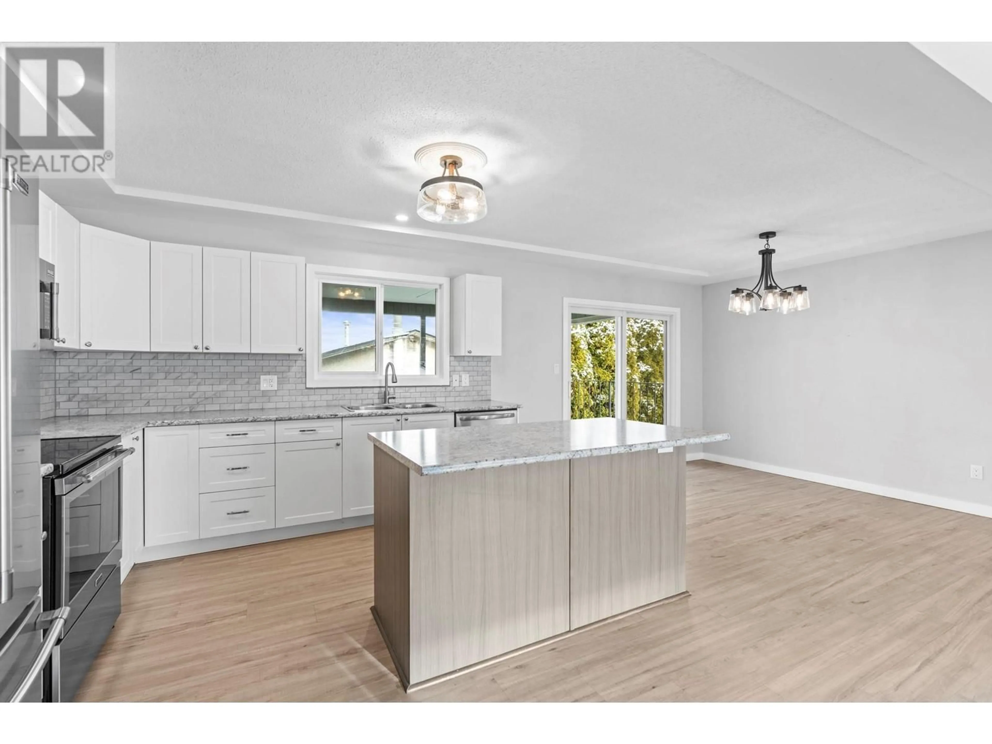 Open concept kitchen, wood/laminate floor for 3417 15 Avenue, Vernon British Columbia V1T1A2