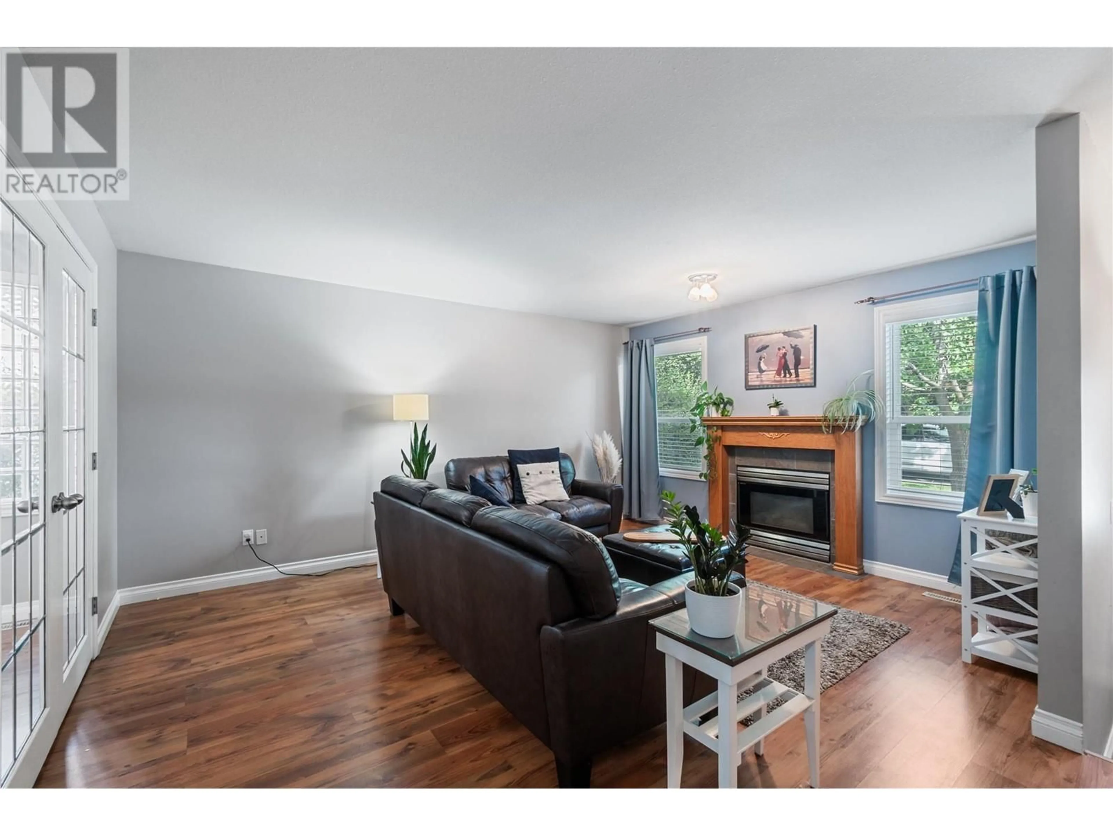 Living room with furniture, wood/laminate floor for 284 Drysdale Boulevard, Kelowna British Columbia V1V1P5