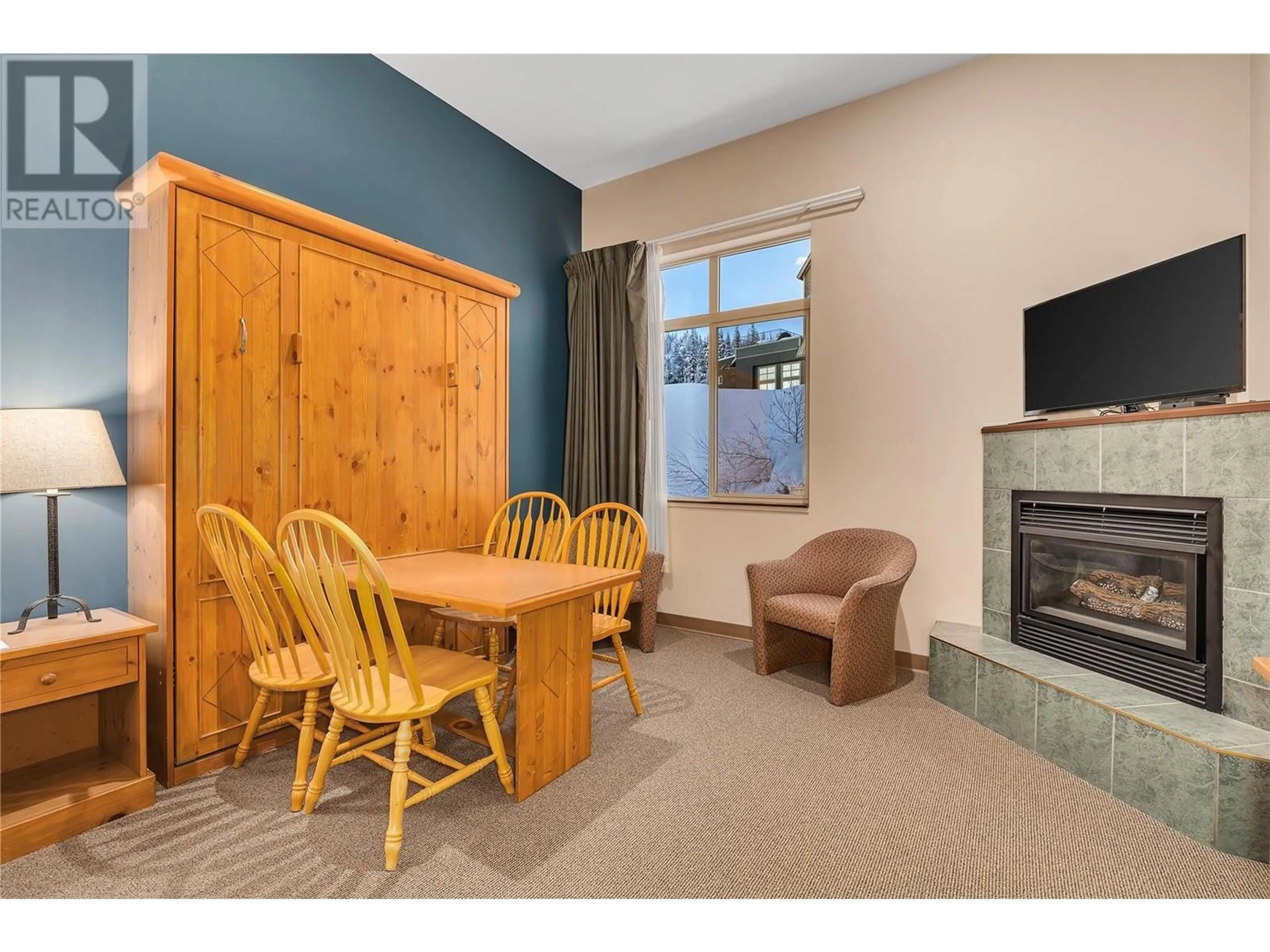Living room with furniture, wood/laminate floor for 117 - 5340 BIG WHITE ROAD, Big White British Columbia V1P1P3