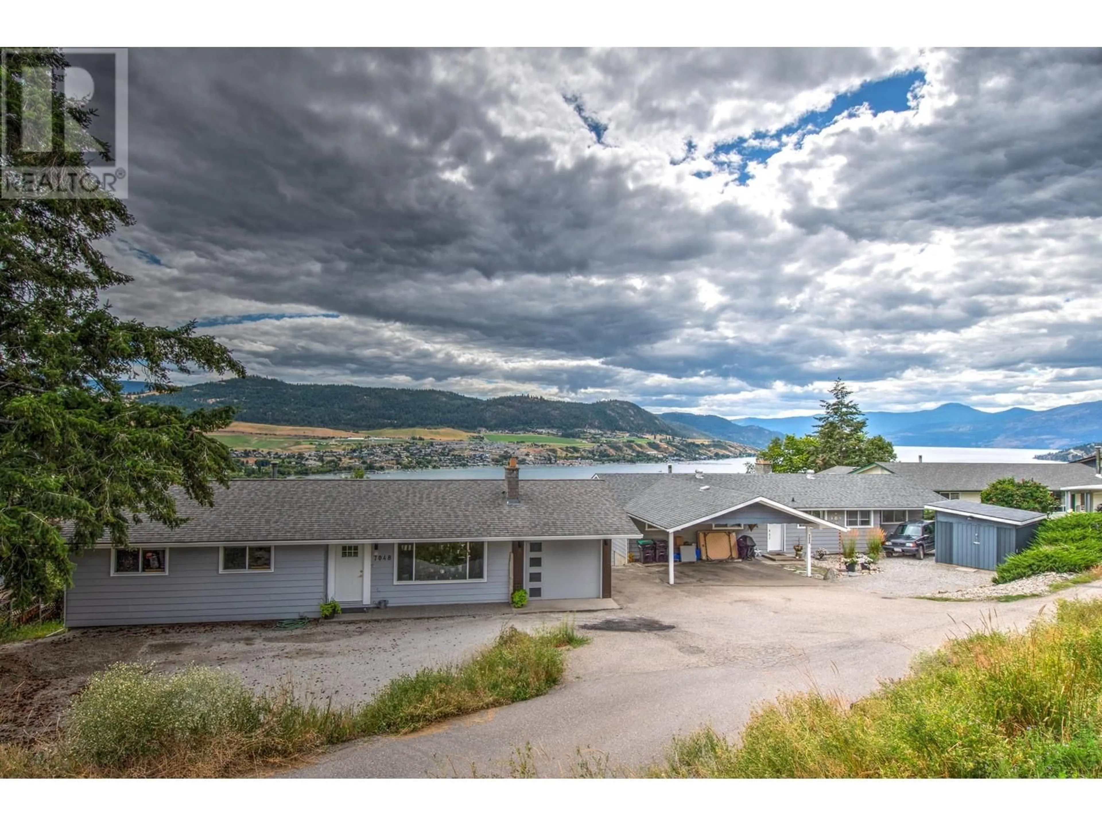 A pic from outside/outdoor area/front of a property/back of a property/a pic from drone, water/lake/river/ocean view for 7048 Appaloosa Way, Vernon British Columbia V1H1B9