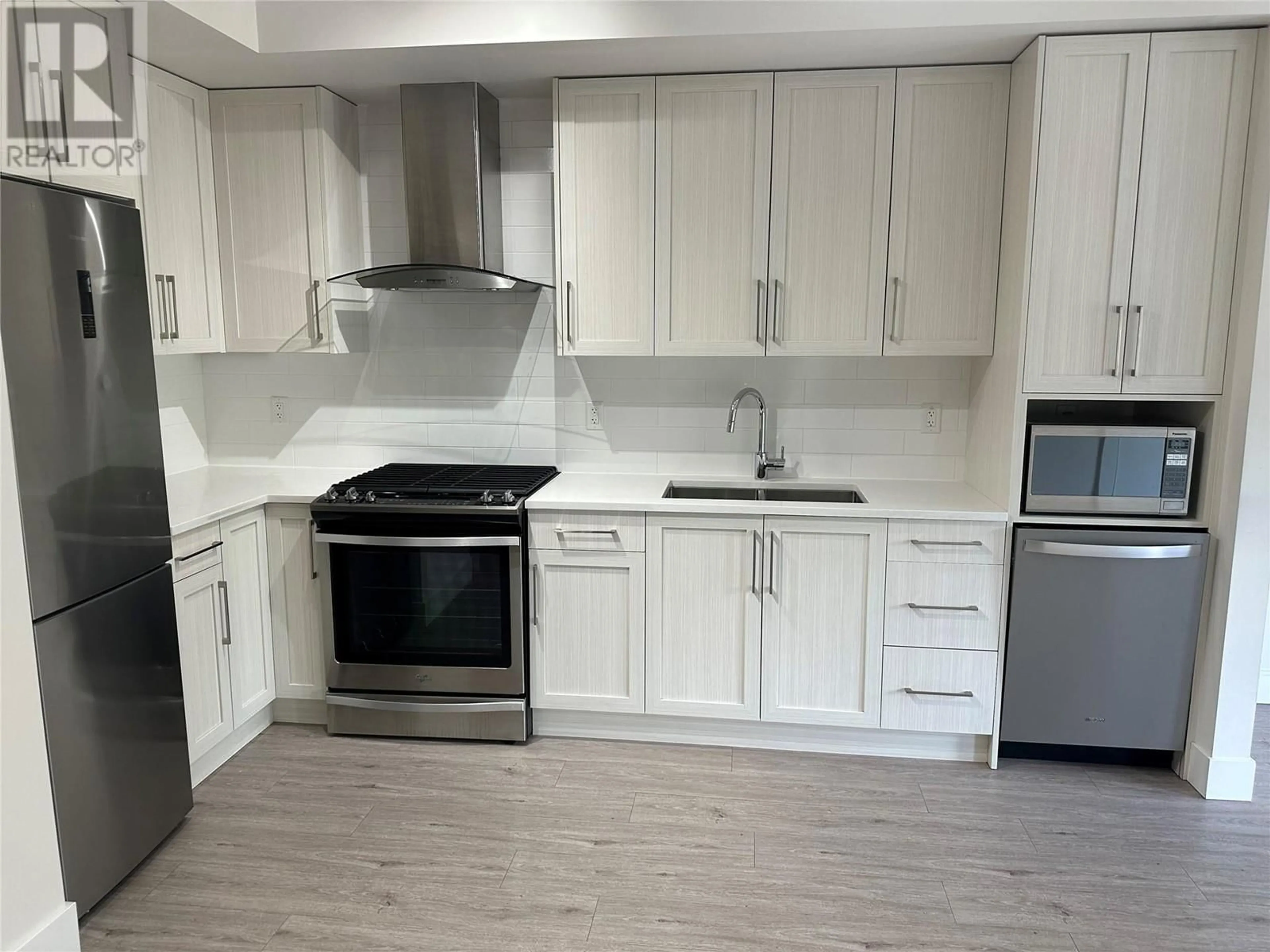 Open concept kitchen, wood/laminate floor for PH16 - 4380 LAKESHORE ROAD, Kelowna British Columbia V1Y0B5