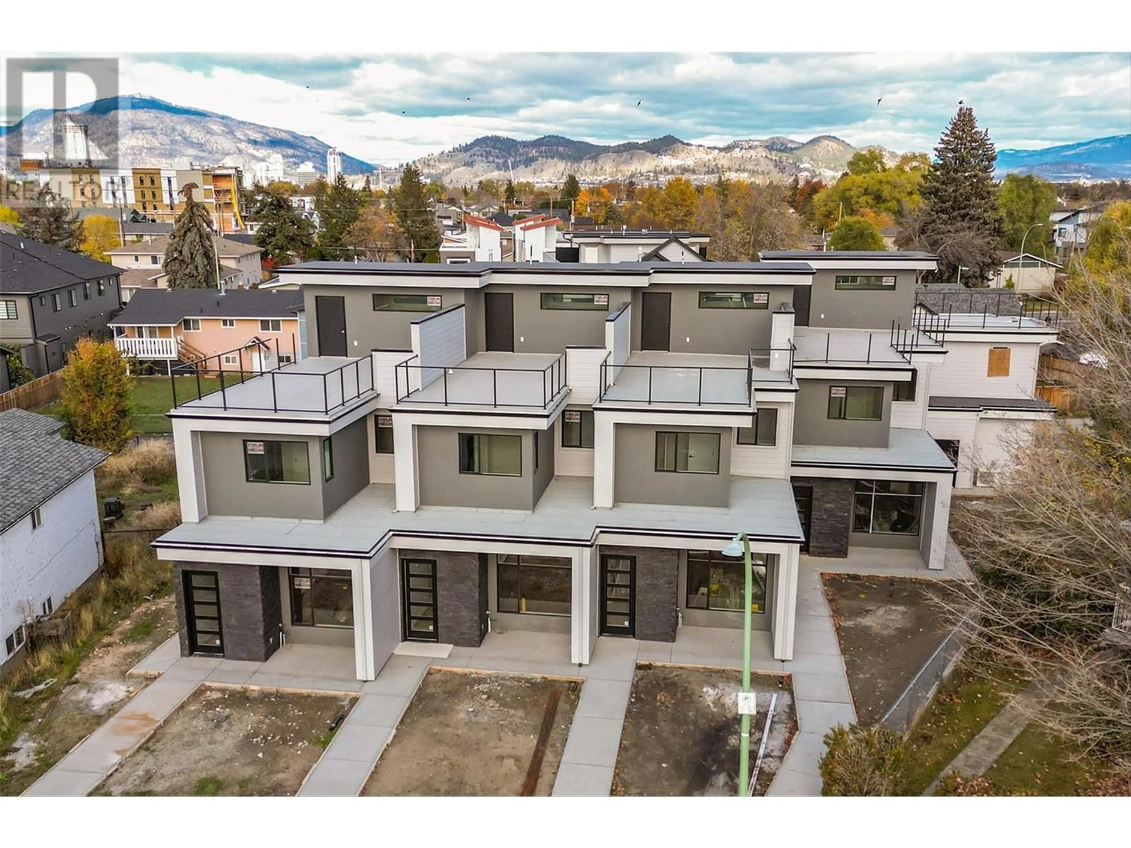 A pic from outside/outdoor area/front of a property/back of a property/a pic from drone, mountain view for 732 Coopland Crescent Unit# 2, Kelowna British Columbia V1Y2V1