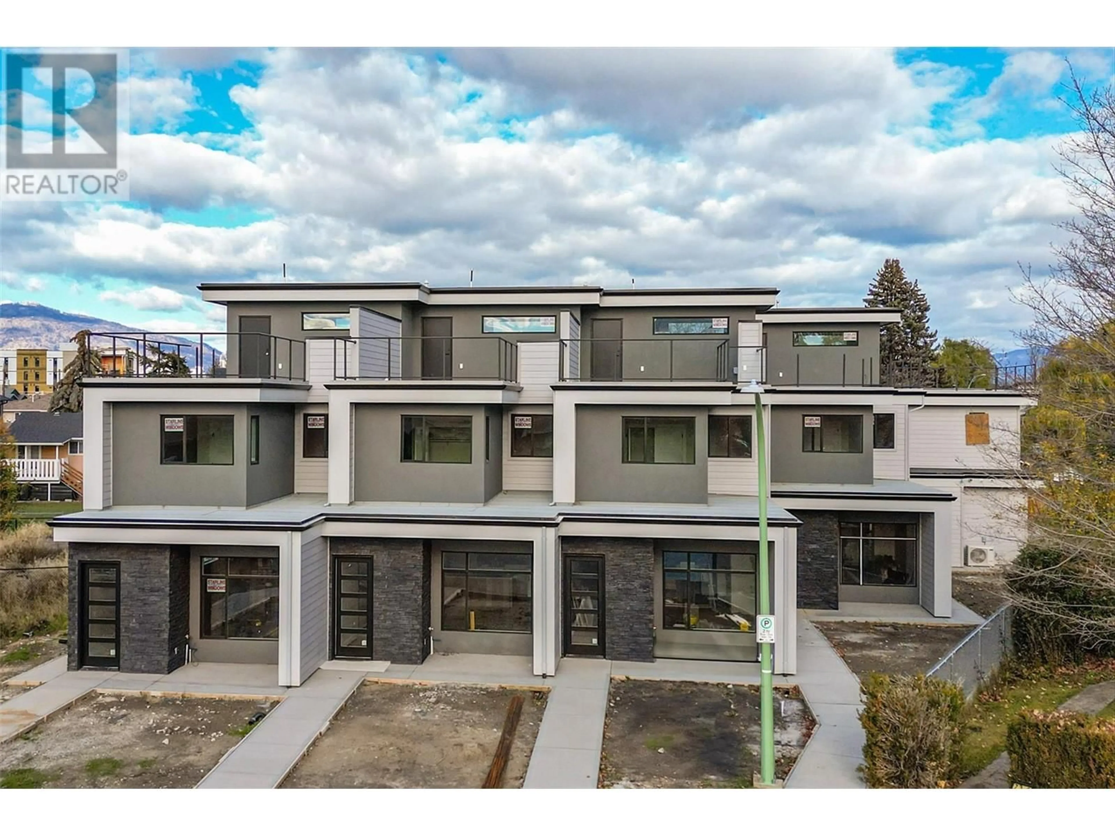 A pic from outside/outdoor area/front of a property/back of a property/a pic from drone, street for 732 Coopland Crescent Unit# 1, Kelowna British Columbia V1Y2V1