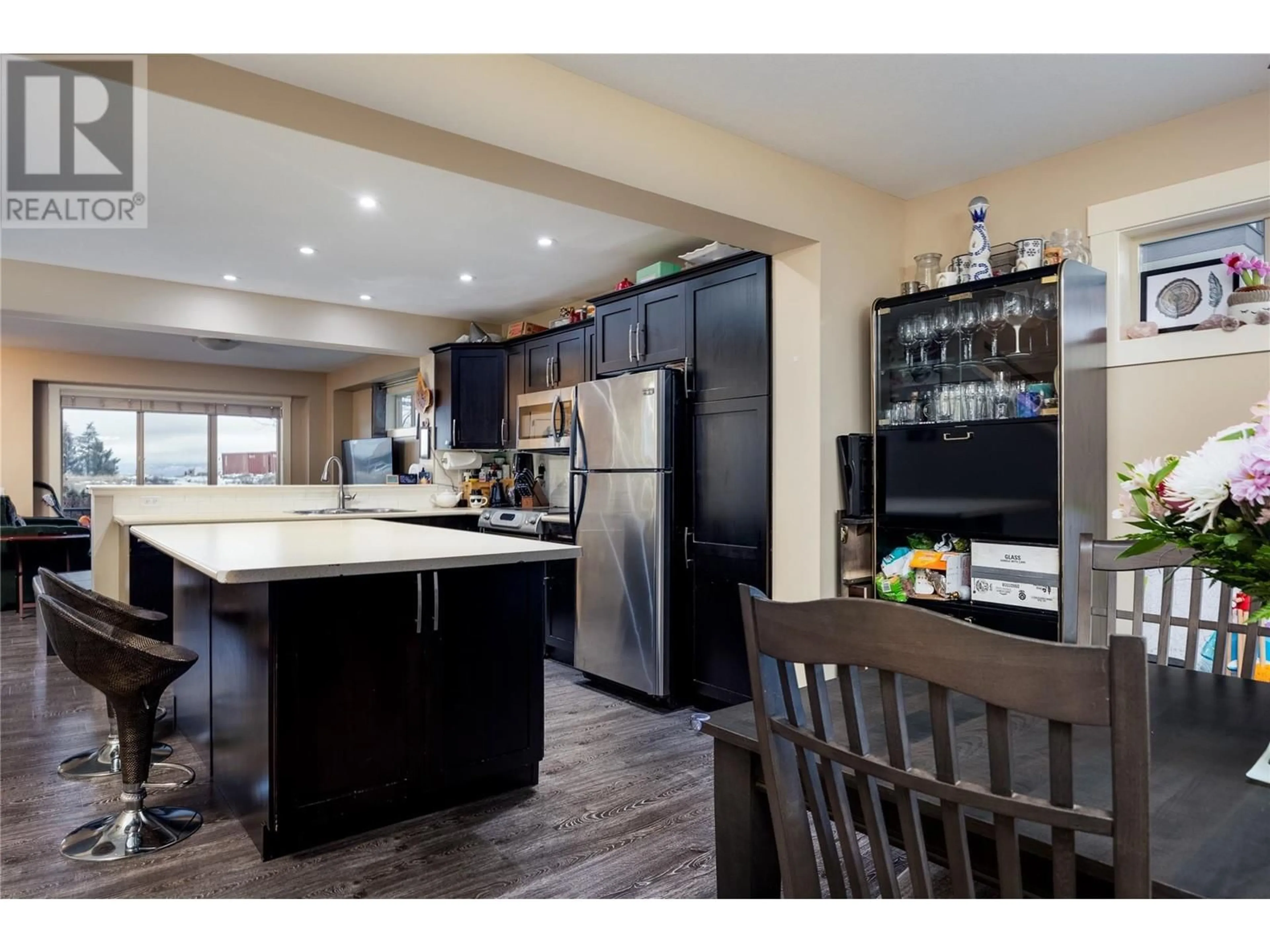 Open concept kitchen, wood/laminate floor for 1651 Lynrick Road Unit# 108, Kelowna British Columbia V1P1R4