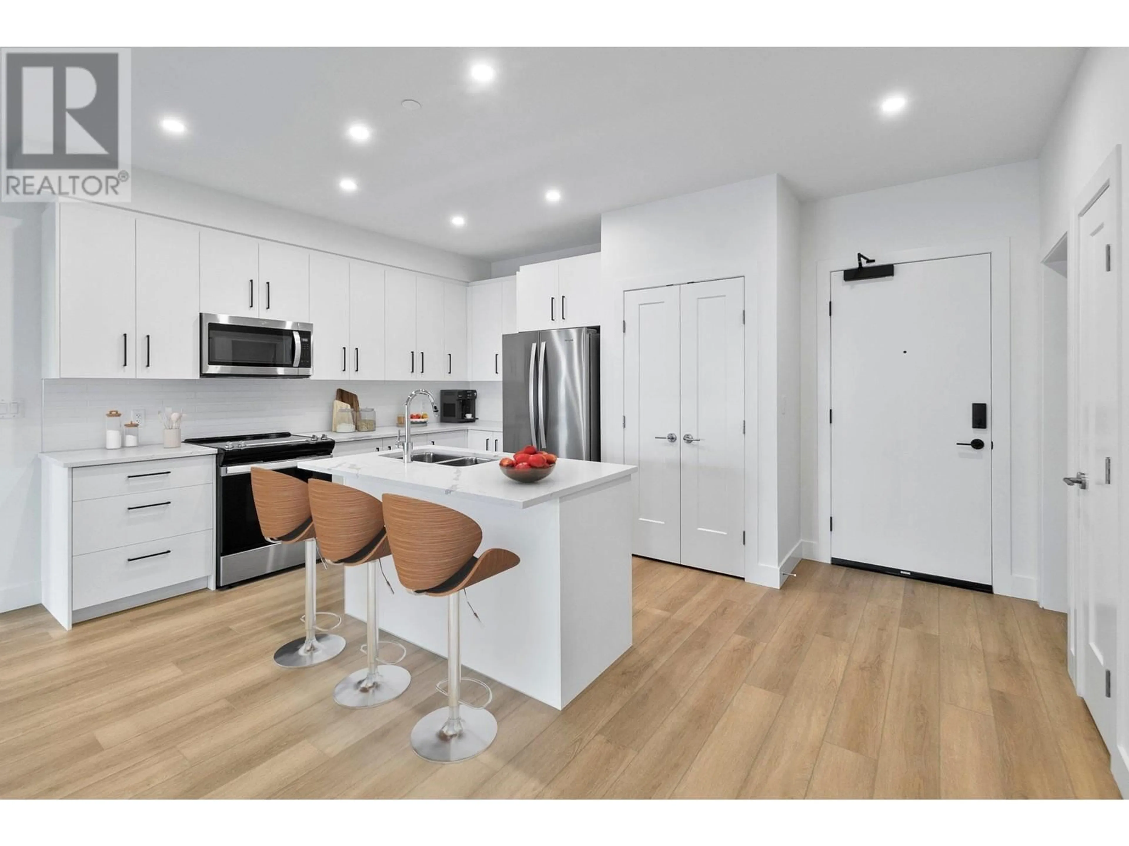 Open concept kitchen, wood/laminate floor for 108 - 3434 MCKINLEY BEACH DRIVE, Kelowna British Columbia V1V0H3