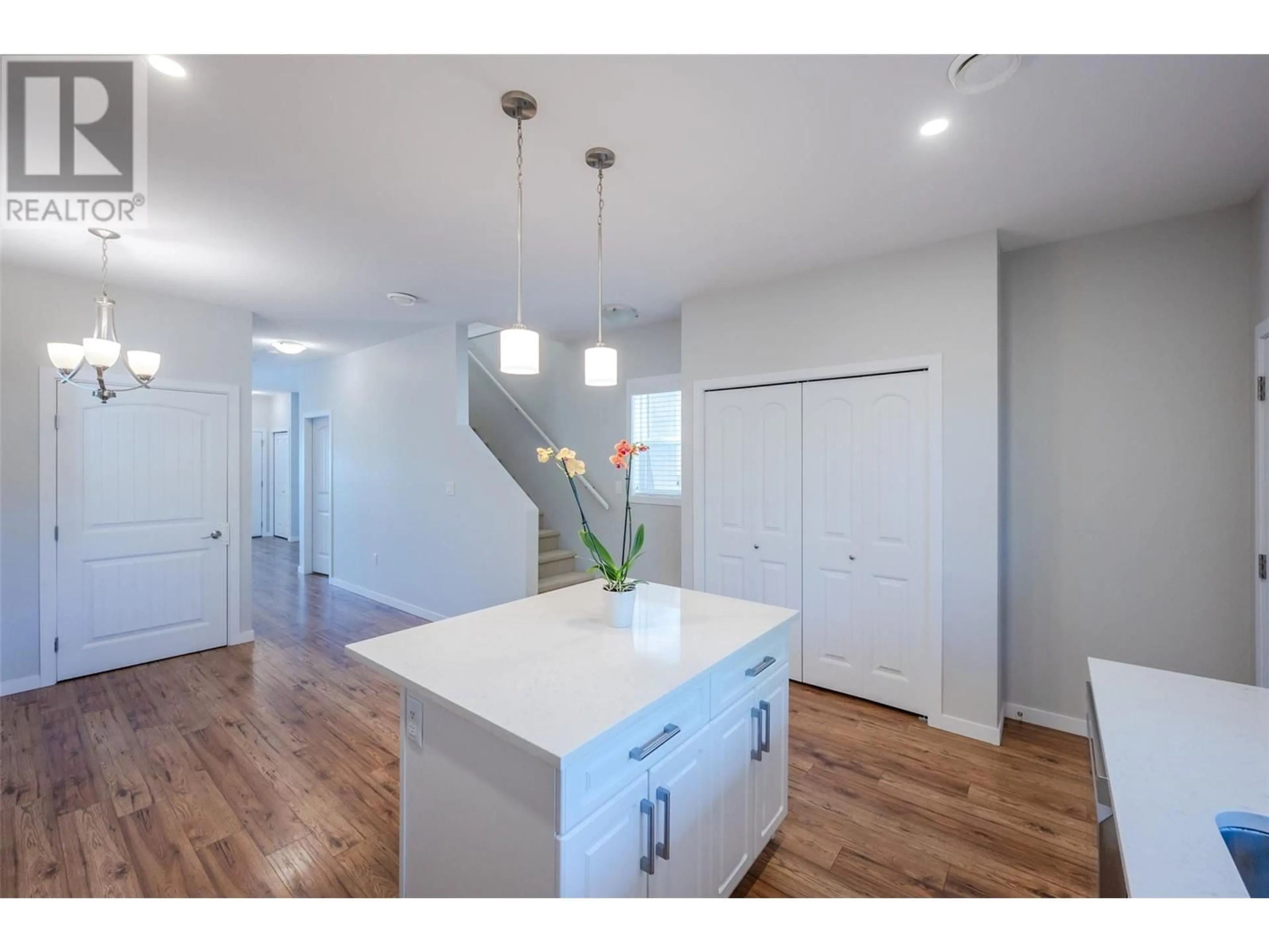 Open concept kitchen, wood/laminate floor for 13620 Kelly Avenue, Summerland British Columbia V0H1Z5