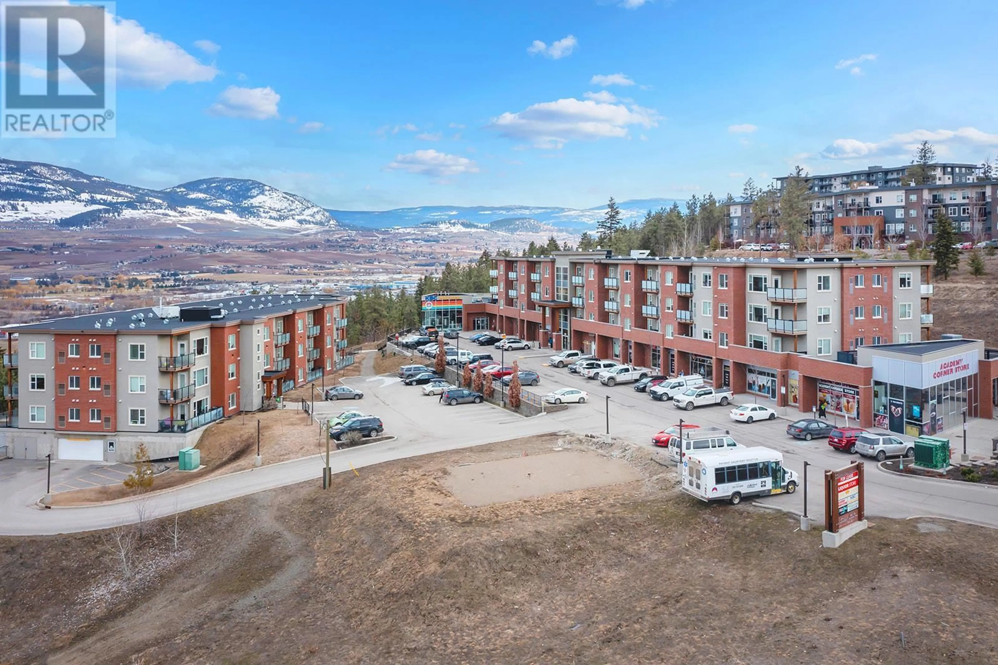 A pic from outside/outdoor area/front of a property/back of a property/a pic from drone, mountain view for 975 Academy Way Unit# 214, Kelowna British Columbia V1V3C8